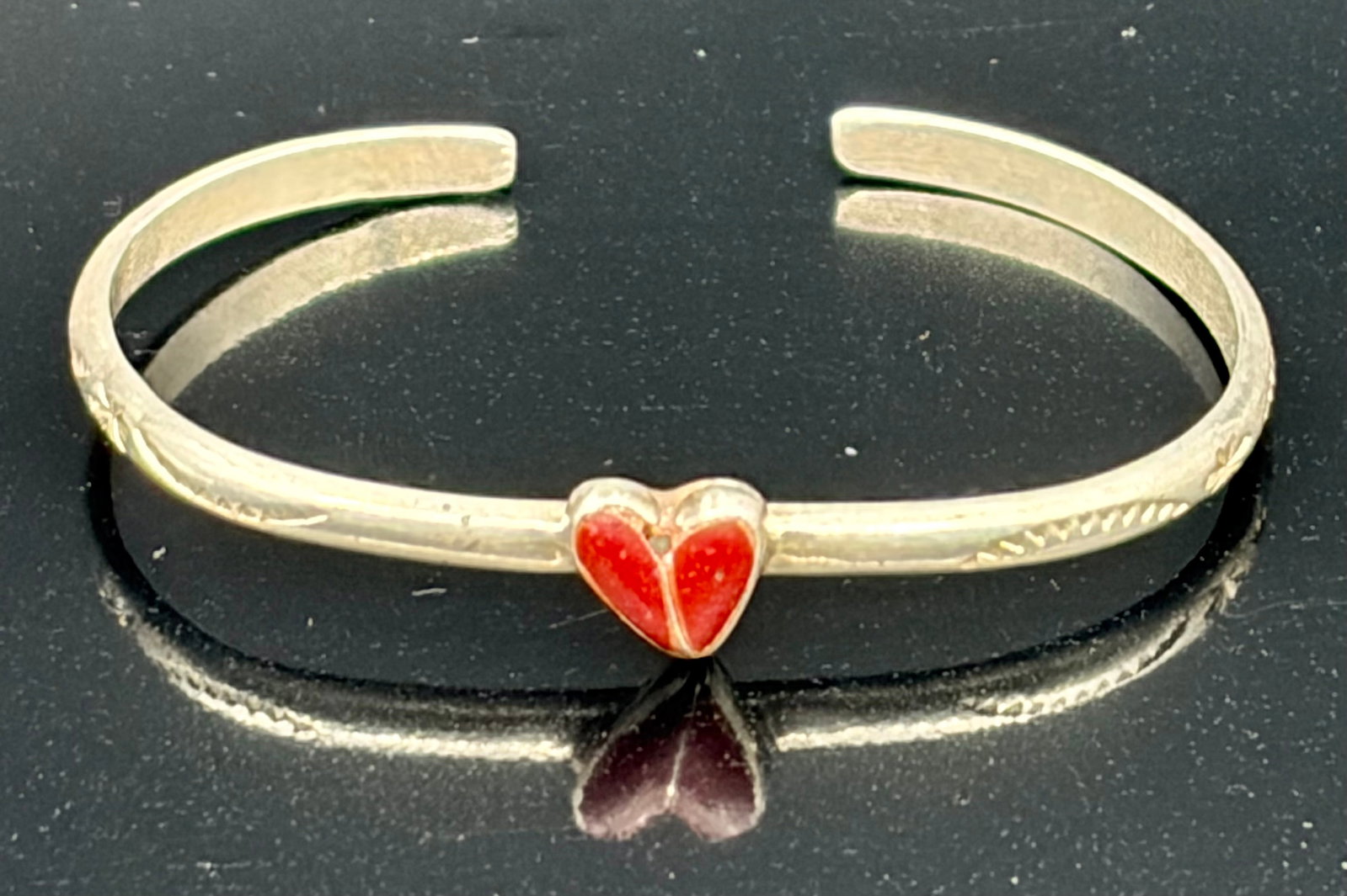 3.7 g Vintage Navajo Silver & Coral Infant Cuff Bracelet: This is a vintage Native American Navajo infant/baby cuff bracelet crafted from sterling silver and featuring a central split-inlay red coral heart. This style represents a deeply rooted Southwestern 