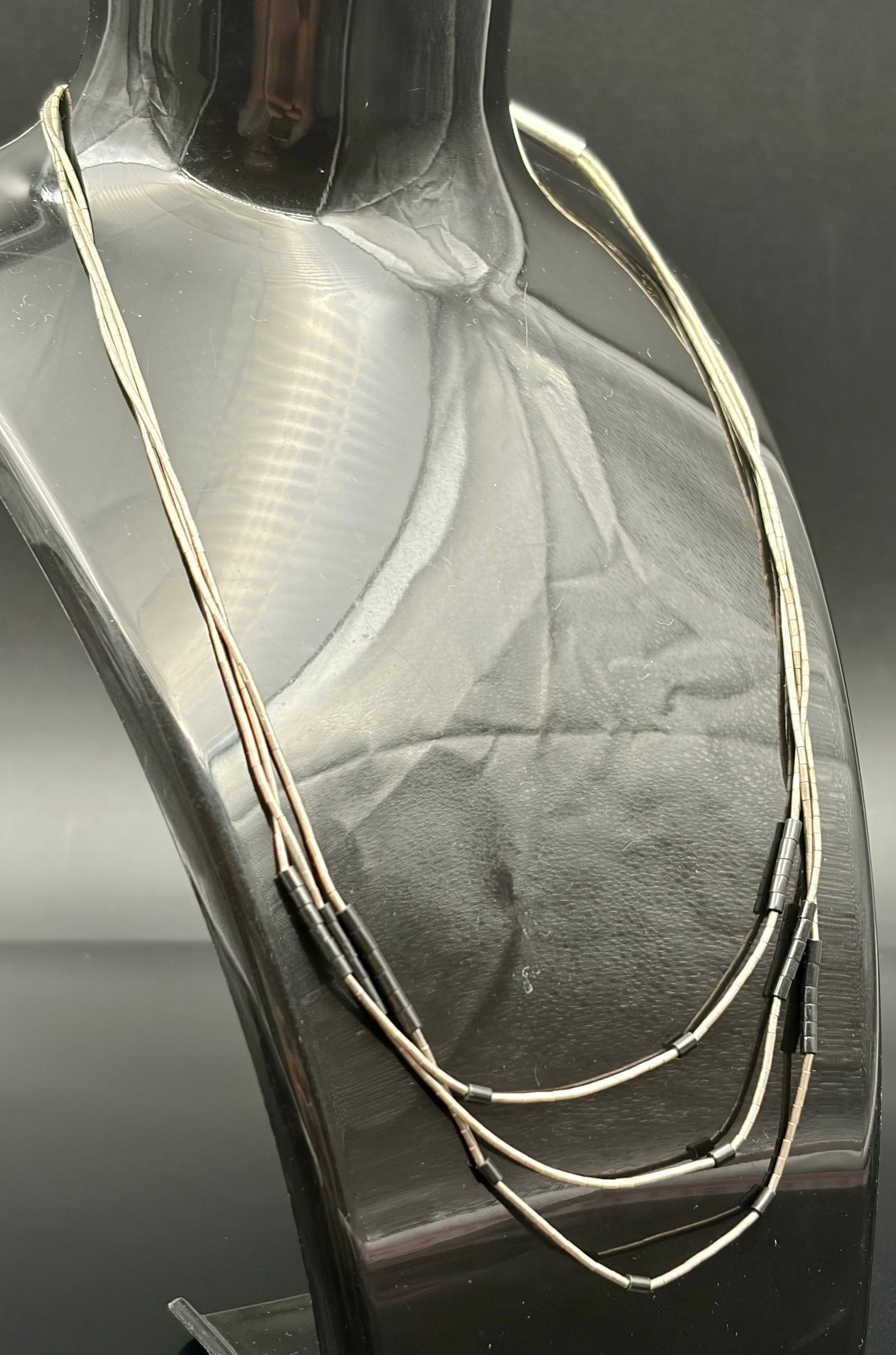 7.3 g Three Strand Liquid Silver Necklace: It features ultra-fine, tubular sterling silver "liquid silver" beads layered in distinct strands, beautifully punctuated by sections of black cylindrical accents. This style is heavily inspired by tr