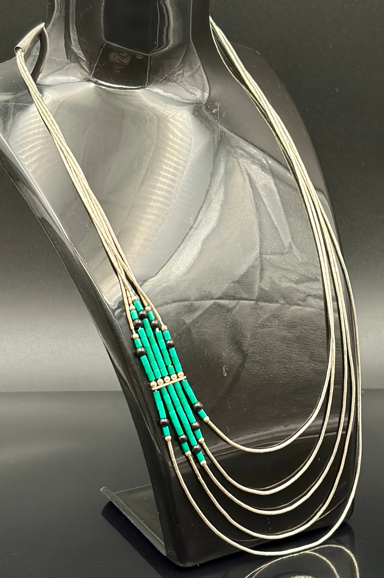 12.7 g Vintage Navajo 5-Strand Liquid Silver Necklace with Off-Center Turquoise & Black Onyx Accent: Beautiful vintage Southwestern multi-strand necklace featuring classic Native American artistry. This piece is elegantly crafted with five fluid strands of sterling liquid silver tubular beads that dr