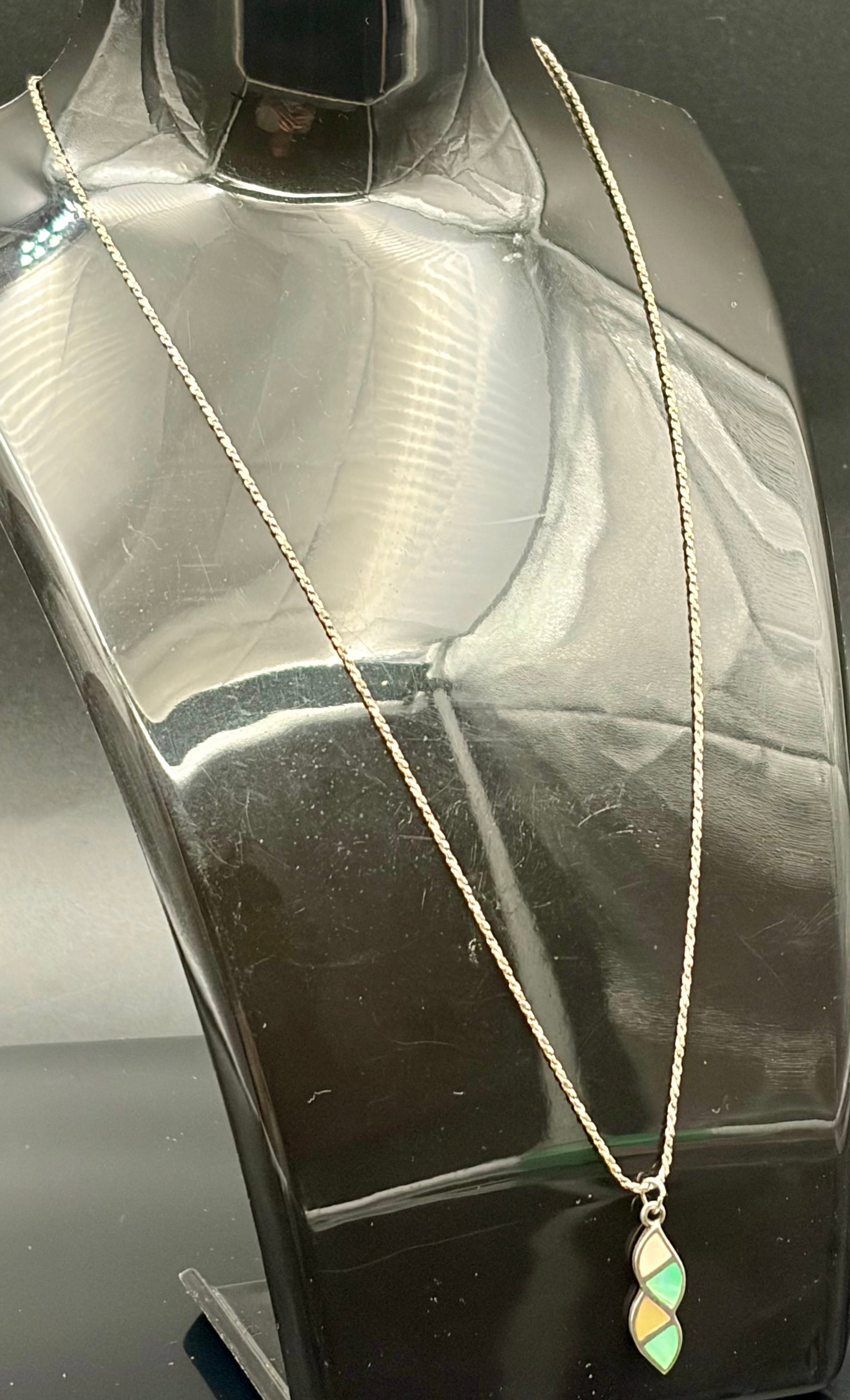 3.4 g Sterling Silver Gemstone inlay vertical wave pendant necklace: This listing features a vintage sterling silver wave-shaped pendant necklace showcasing a multi-color mother-of-pearl or lab-opal channel inlay.