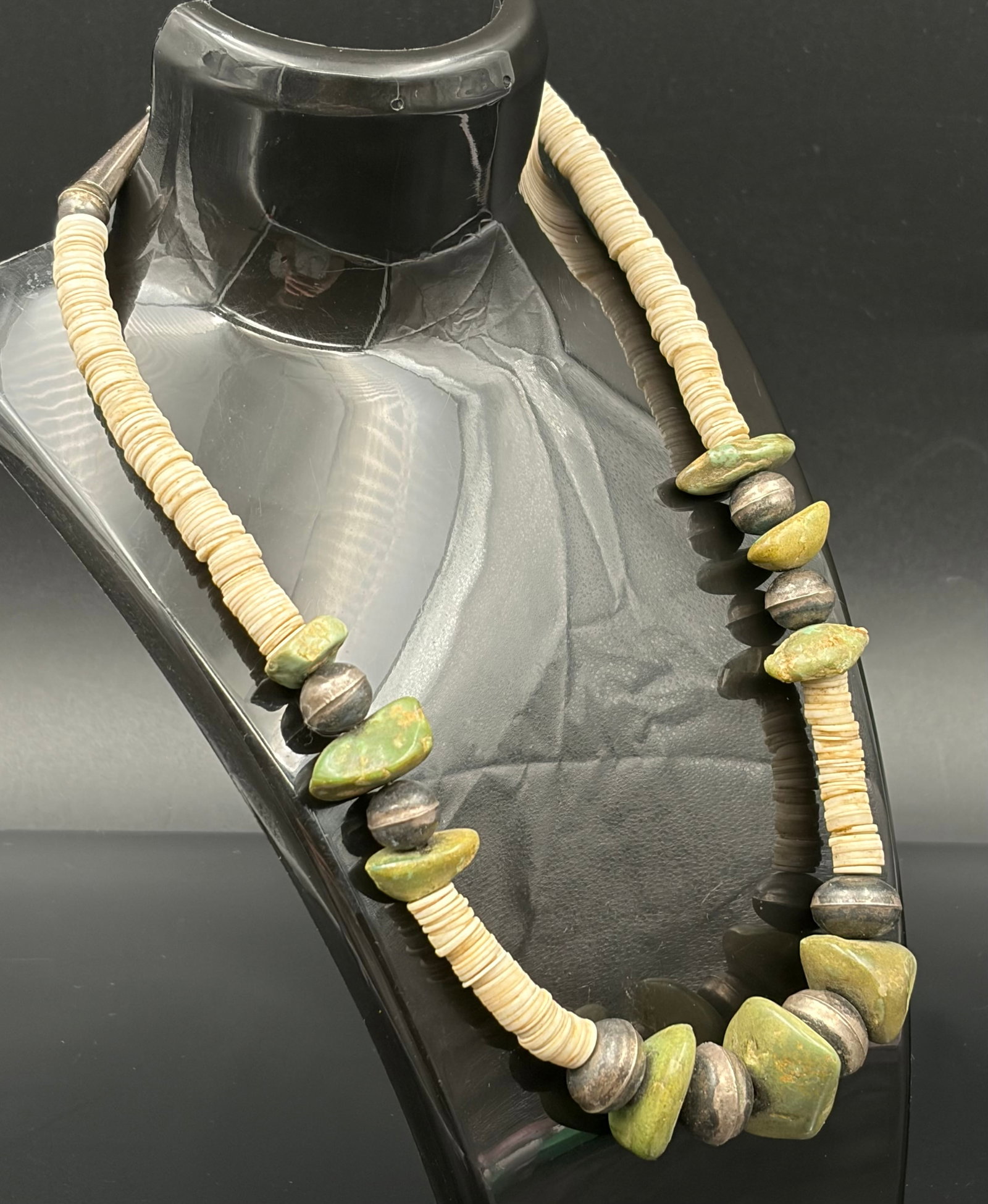 50.6 g Vintage Native American Shell Heishi, Green Turquoise, and Sterling Silver Bead Necklace: This striking, single-strand Native American necklace features a beautiful combination of organic textures and southwestern materials, weighing a total of 50.6 grams.