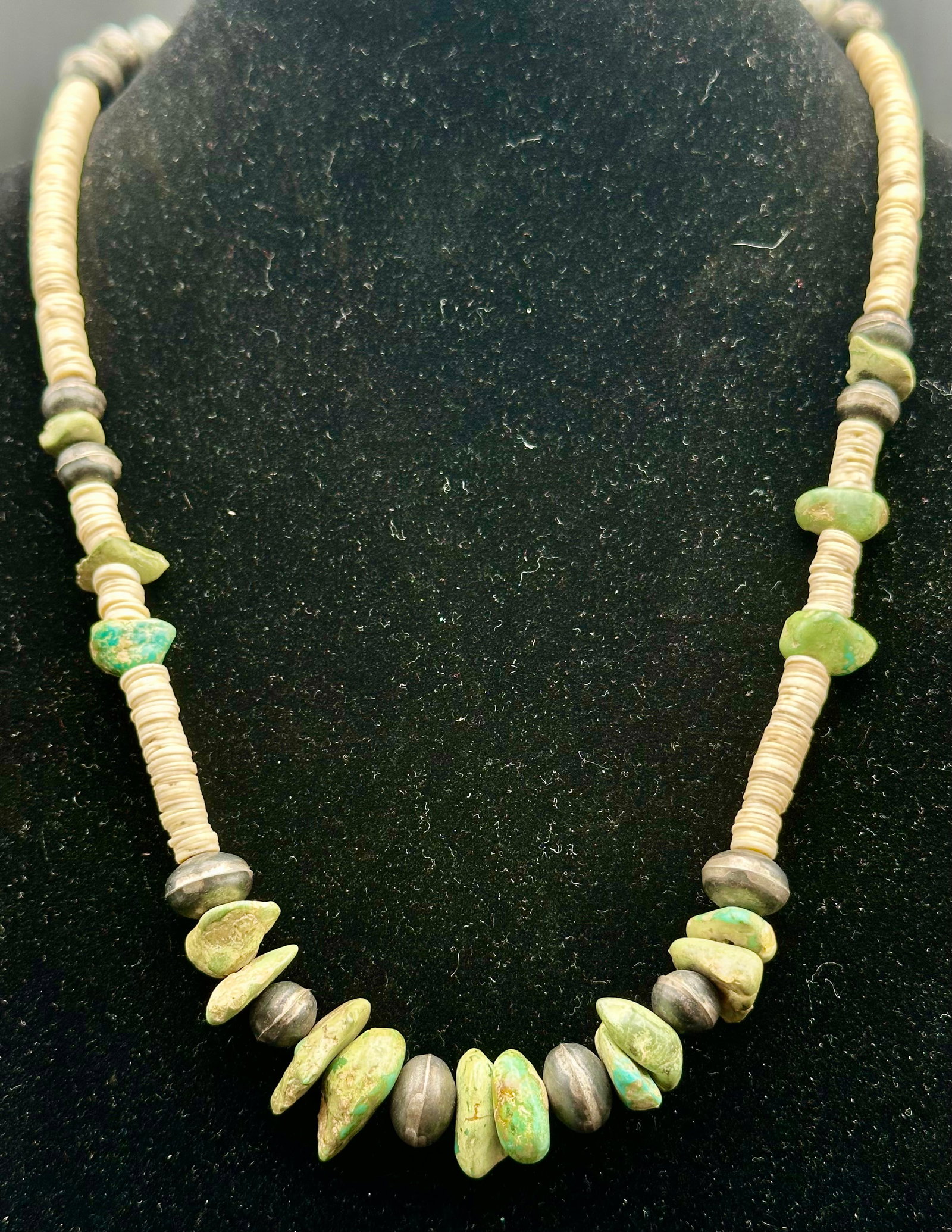 Vintage Native American Turquoise Nugget Heishi Silver Bead Necklace: Vintage Native American necklace with chunky turquoise nuggets, shell heishi, and handmade silver beads. Finished with silver cone ends and a hook closure. Measures approximately 26 inches long. Unsig