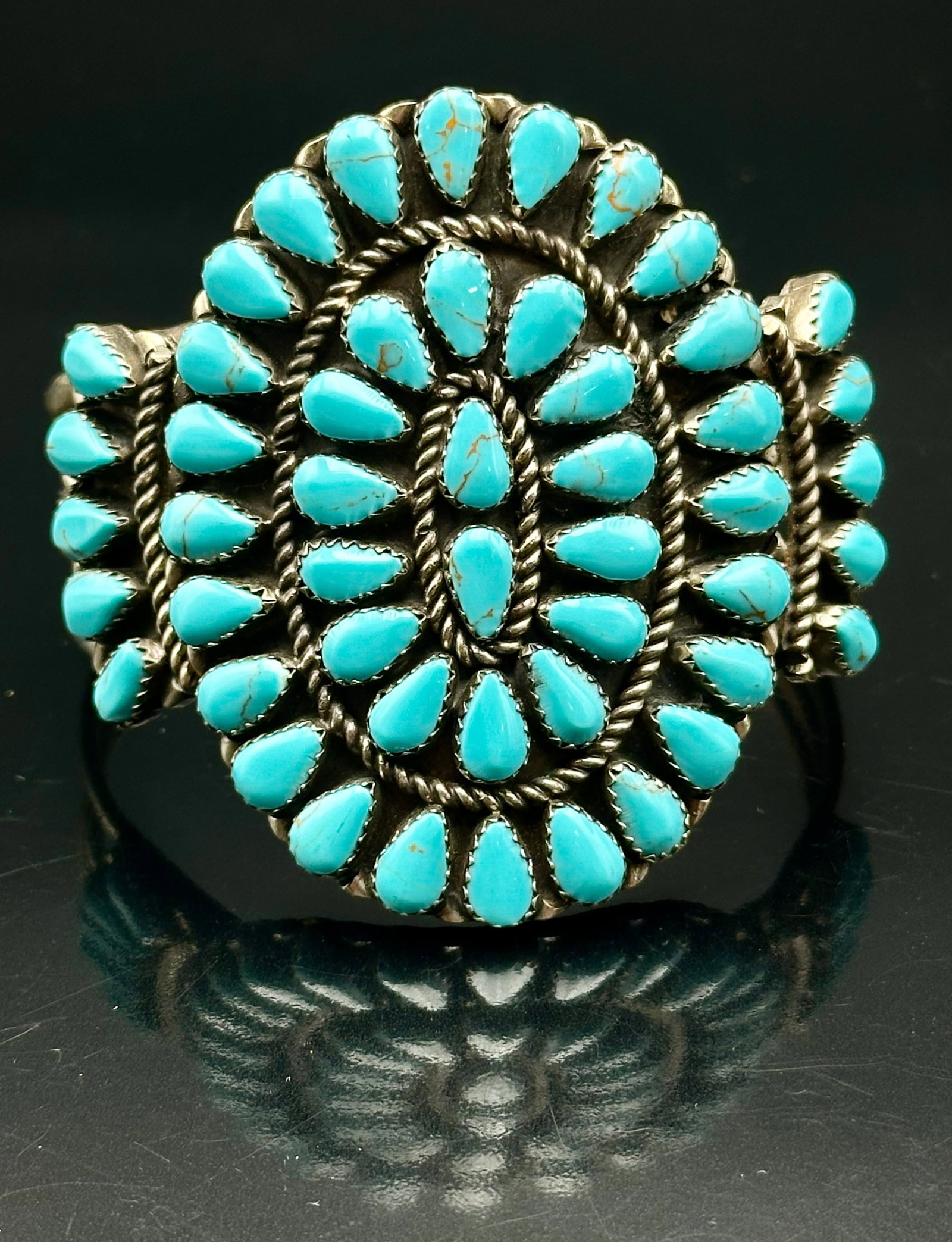 49g Vintage Navajo Sterling Silver Turquoise Cluster Cuff Bracelet: Vintage Navajo sterling silver cuff bracelet with many turquoise stones. Large cluster design with rope details and nice old patina. Weighs 49g. No artist signature found. Please see pictures for cond