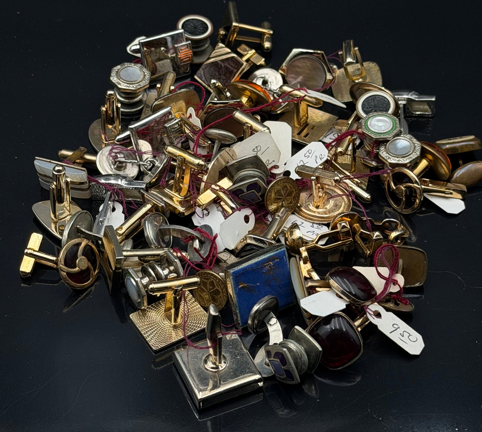 Vintage Men's Cufflinks Mixed Lot: Large mixed lot of vintage men’s cufflinks in different styles and designs. Includes gold-tone and silver-tone cufflinks, blue stone-look squares, mother-of-pearl style accents, dark red stones, ena