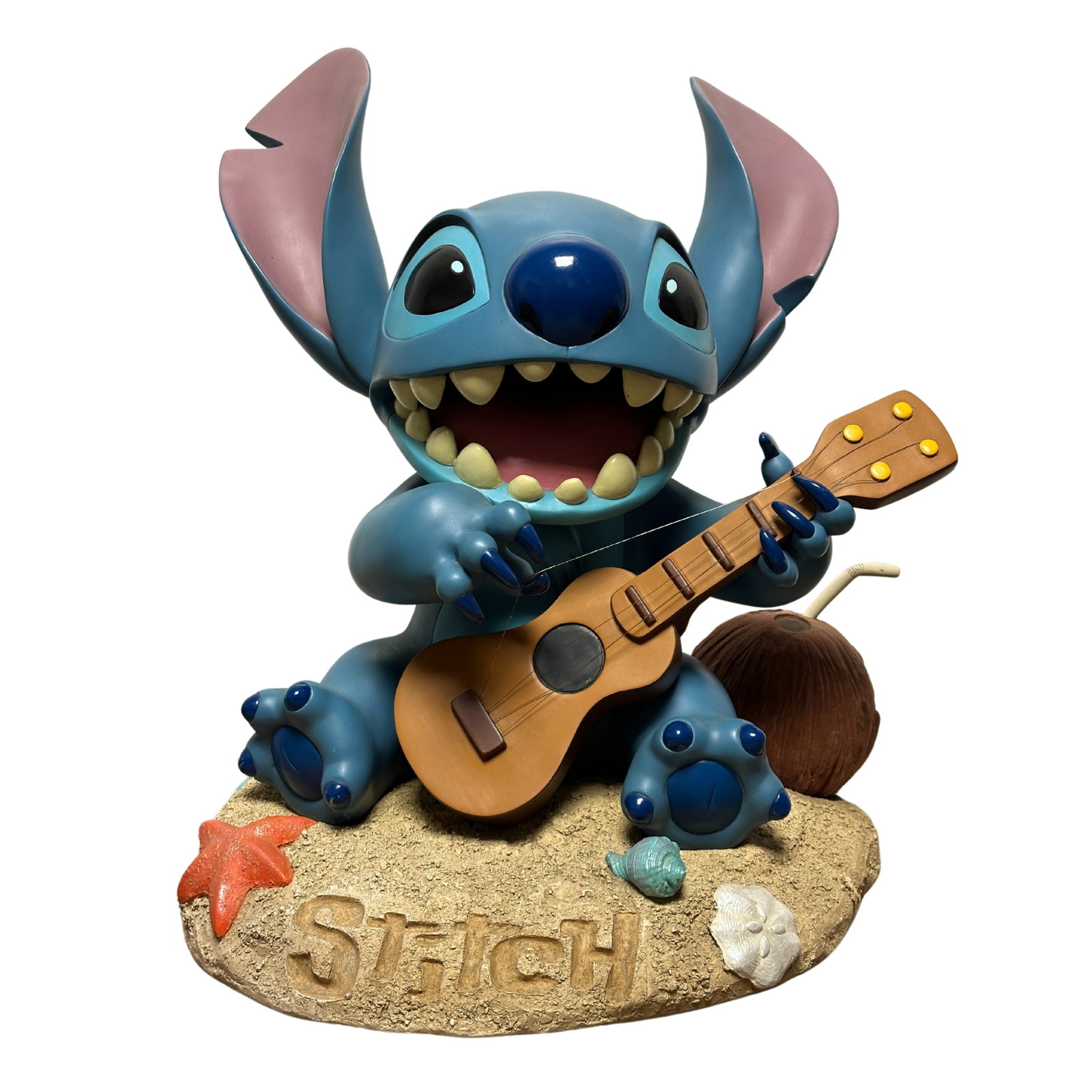 Disney Lilo & Stitch Big Fig Figurine: A Disney Lilo & Stitch Big Fig Figurine. This piece features stitch playing a Ukulele on the beach. It measures 21" tall.