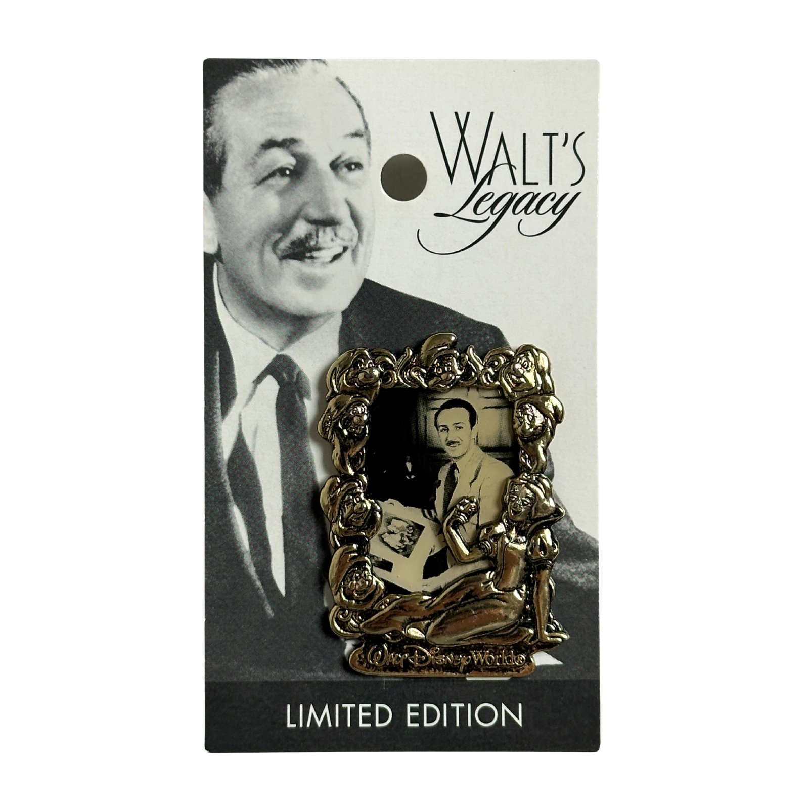 Disney WDW Walt's Legacy Snow White Pin: A Piece Of Disney History Series 2 DCL Disney Cruise Line Pin. This features a black and white picture of Walt Disney surrounded by a gold frame featuring the faces of Snow White and the Seven Dwarfs.