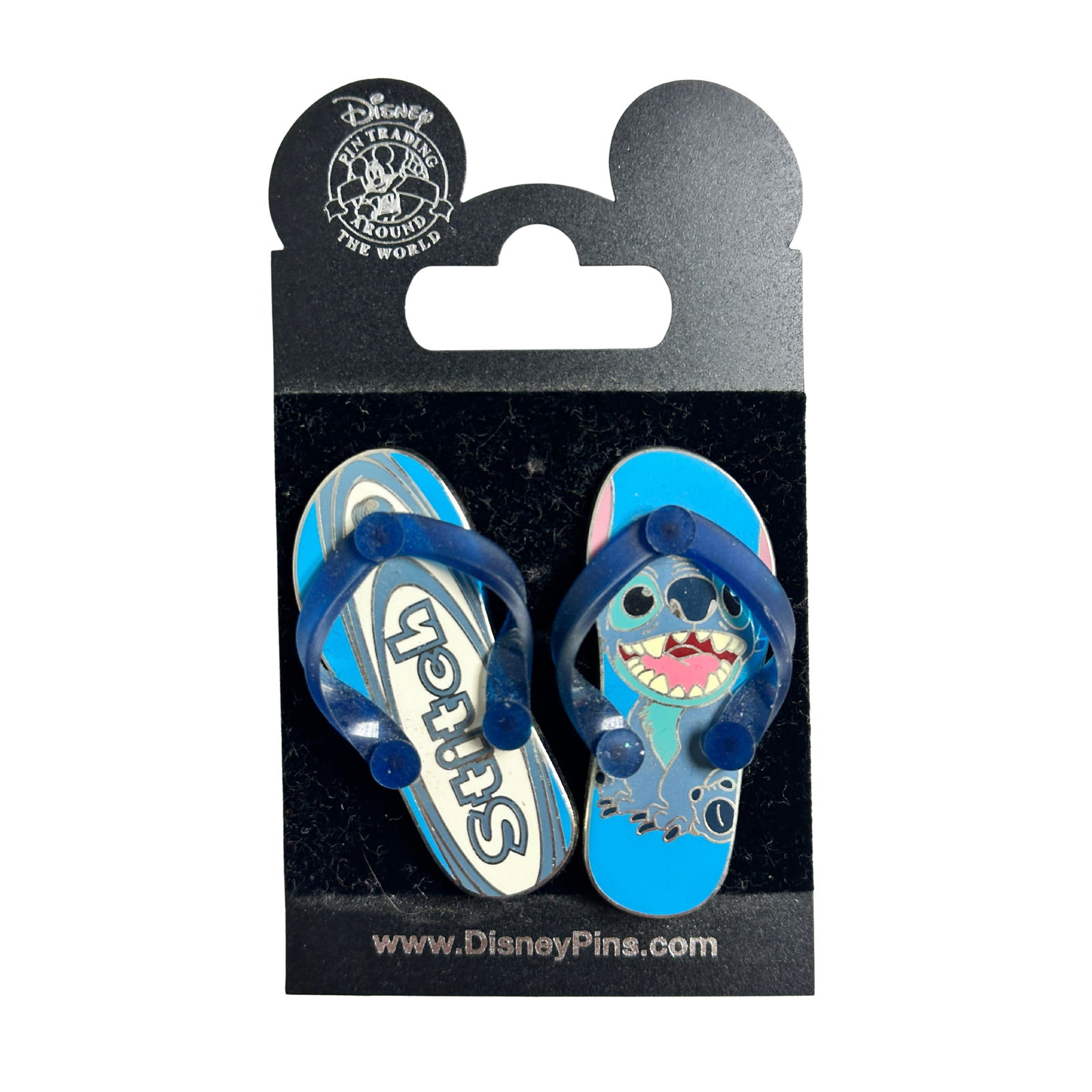 Disney WDW Stitch Flip Flop Sandal 2006 Pin: Disney WDW Stitch Flip Flop Sandal Pin. This features a pair of flip flops. The left sandal has the word Stitch written on it and the right sandal has a picture of a sitting Stitch on it, with a big s