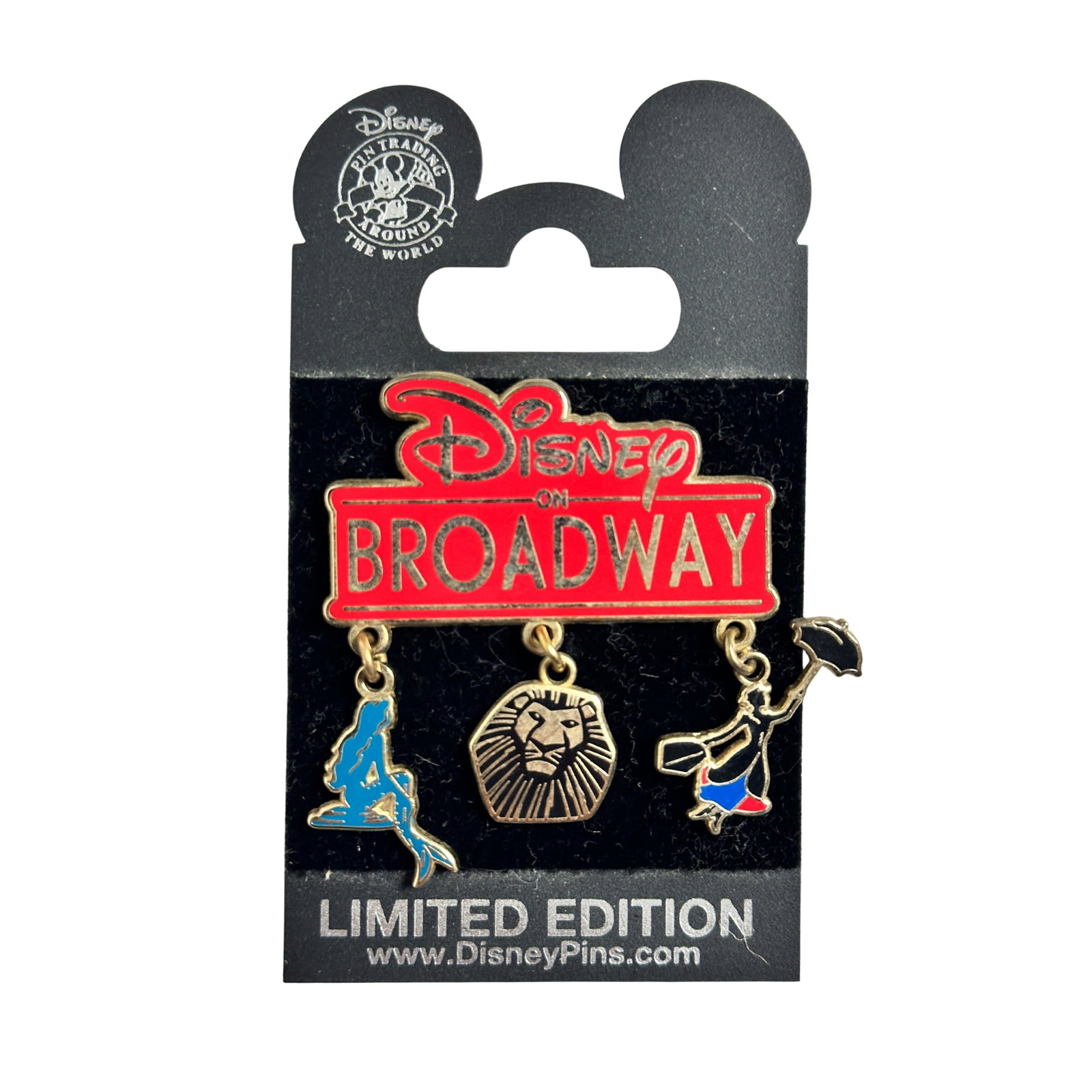 Disney On Broadway LE Pin: Disney On Broadway LE Pin. The main piece is Red with gold letters. The red top says Disney on Broadway. It has 3 dangles. One is the Little Mermaid. The second is a Lion King head. The third is Mary 