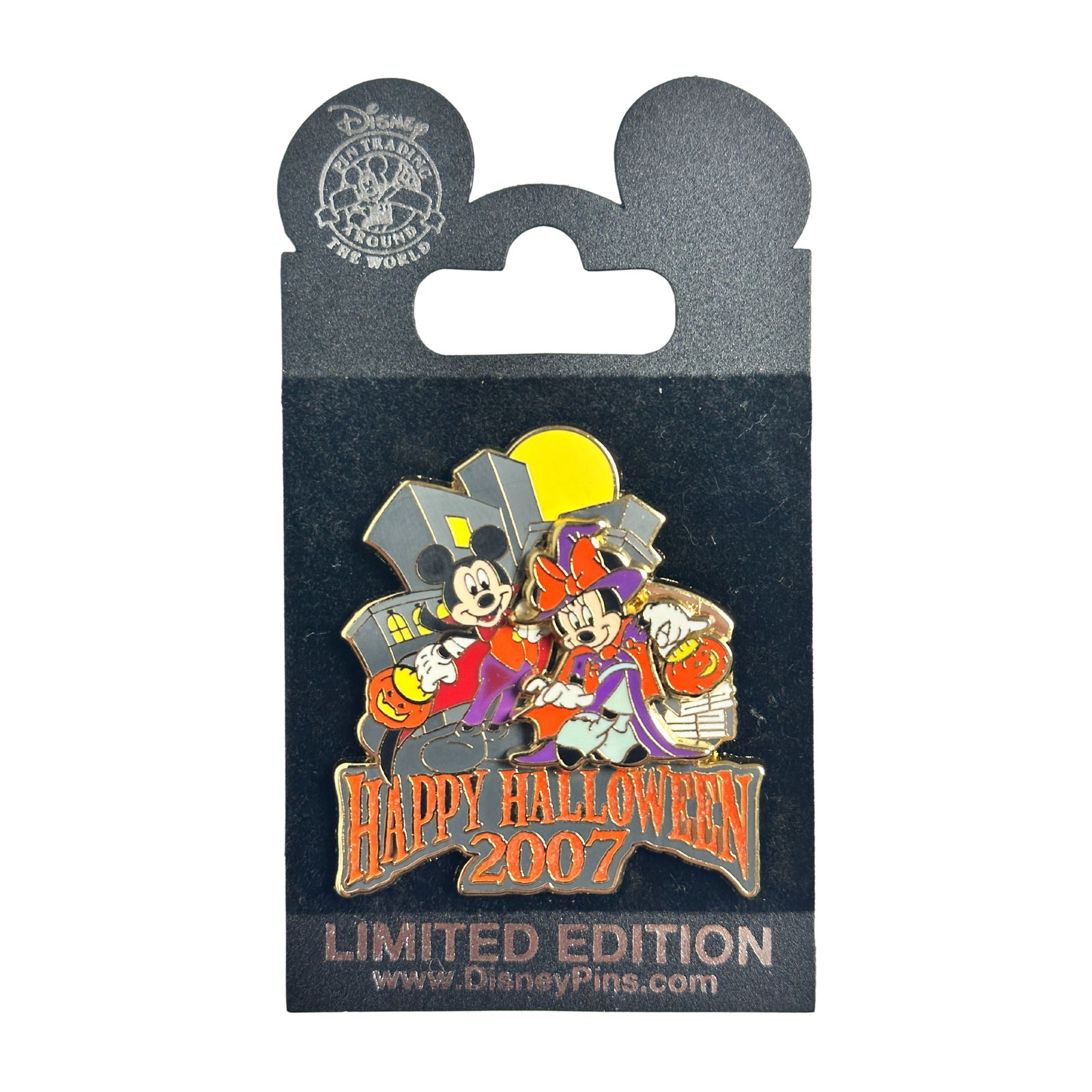 Disney NYC Mickey & Minnie Happy Halloween 2007 Pin: Disney NYC Mickey & Minnie Happy Halloween 2007 Pin. Mickey Mouse is wearing a vampire costume of purple pants and a red & black cape. Minnie is dressed as a witch with a blue and purple dress, red ca