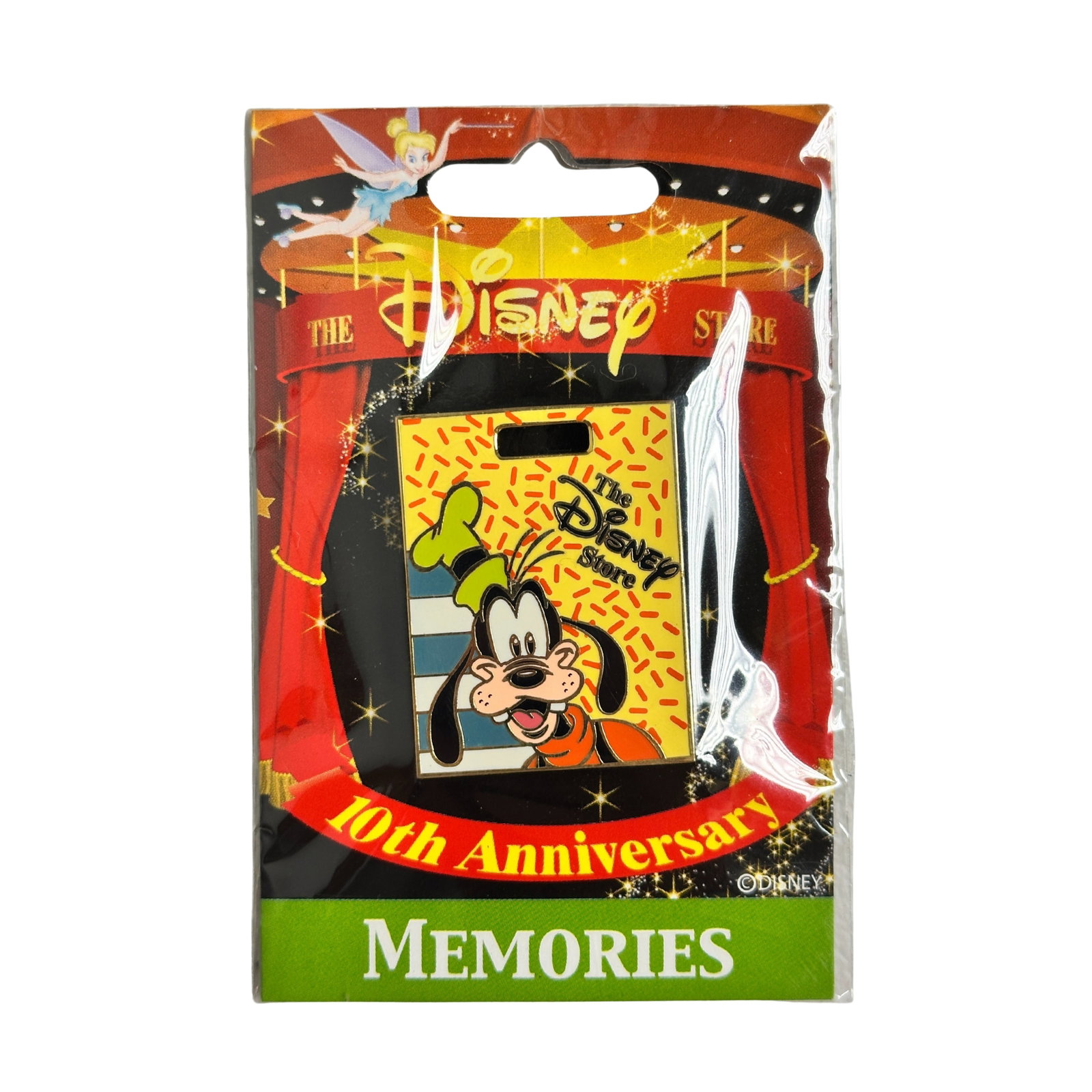 Disney JDS 10th Anniversary Memories Goofy Pin: Disney JDS 10th Anniversary Memories Goofy Pin. This features Goofy a DS shopping bag.Bottom left corner is green and white horizontal stripes. The rest of the bag has a yellow background with lots of