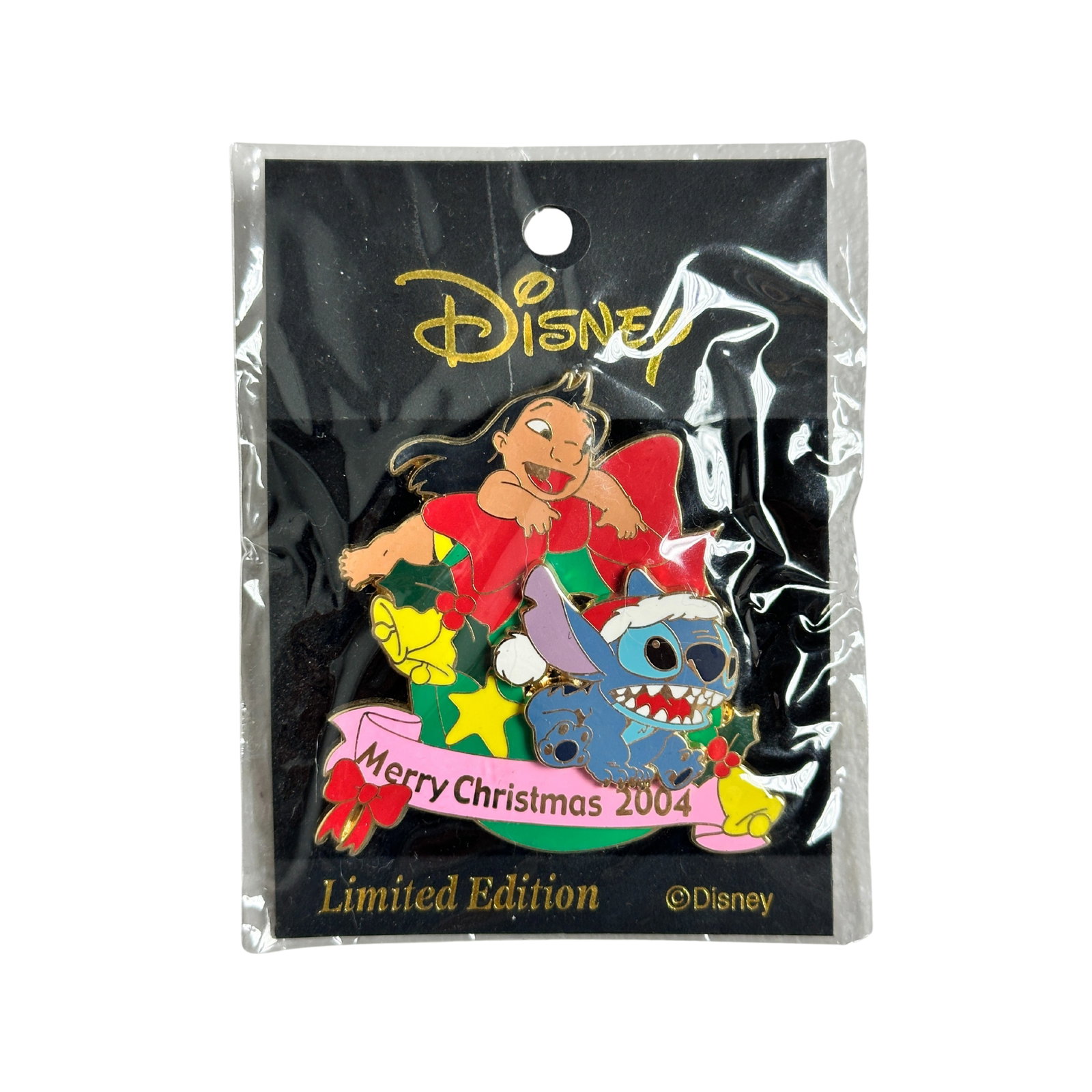 Disney Lilo & Stitch Merry Christmas 2004 Wreath Pin: Disney Lilo & Stitch Merry Christmas 2004 Wreath Pin. This Limited Edition Pin-on-Pin features Stitch wearing Santa Cap. Lilo at top of decorated Christmas wreath with red ribbon at top. Botton has pi