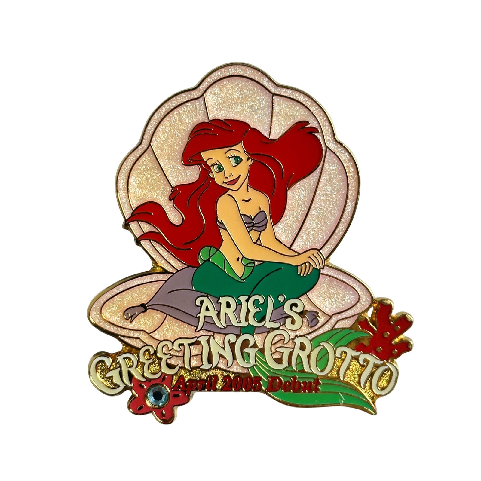 Disney TDR Ariel's Greeting Grotto 2005 Debut Pin: Disney TDR Ariel's Greeting Grotto 2005 Debut Pin. This pin features Ariel (from "The Little Mermaid) sitting in a pink glitter shell and it says "Ariel's Greeting Grotto April 2005 Debut". There is a