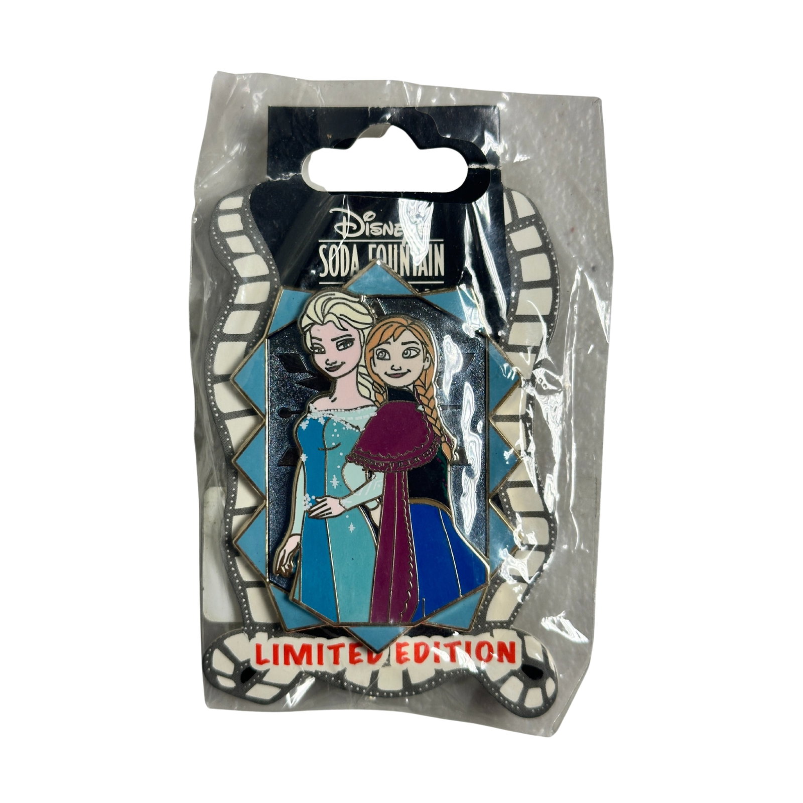 Disney DSSH Soda Fountain Frozen Anna & Elsa LE Pin: Disney DSSH Soda Fountain Frozen Elsa LE Pin. This DSSH Ghirardelli Soda Fountain pin features Anna & Elsa, from Disney's Frozen. They are against each other's backs while smiling and looking at each 