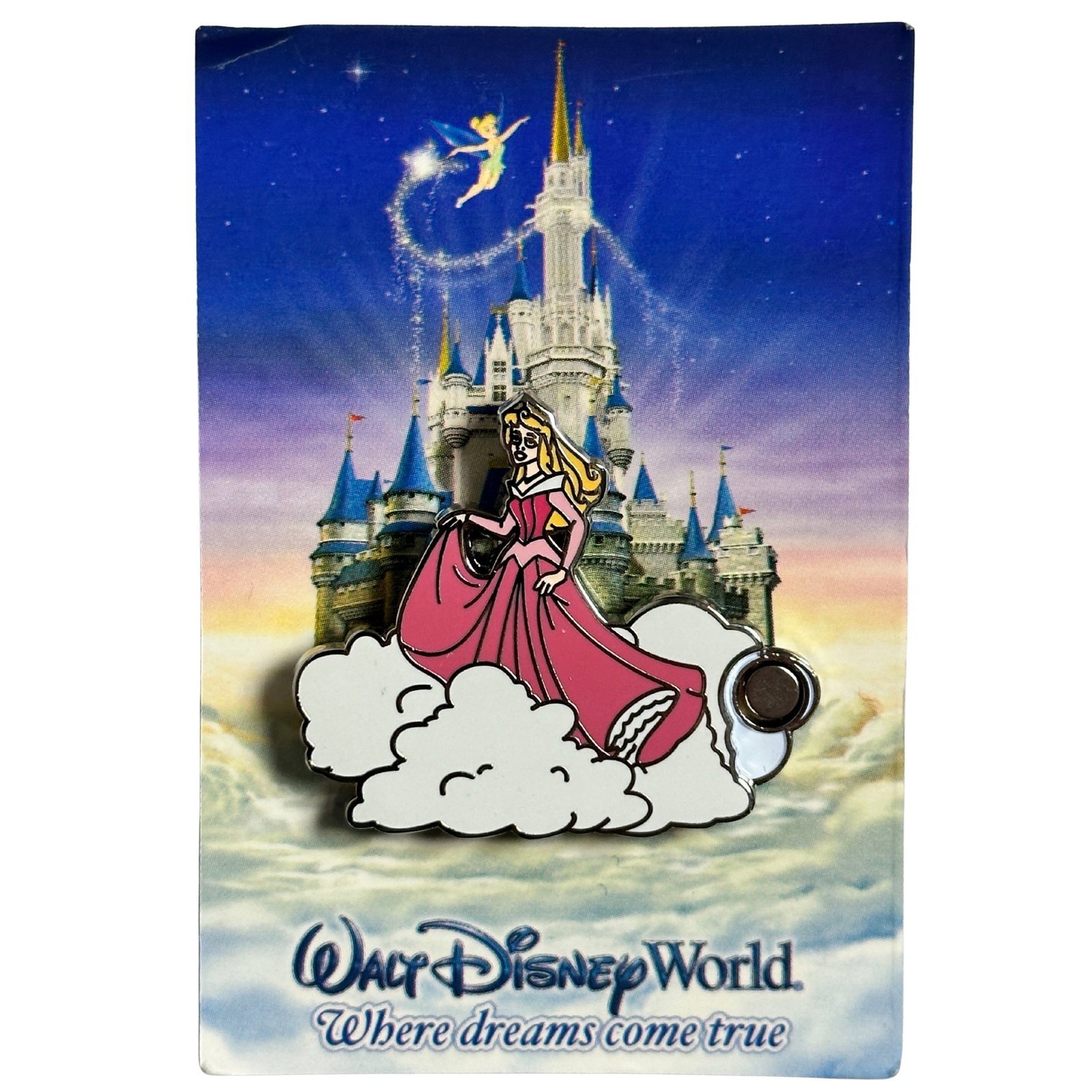 Disney WDW Sleeping Beauty Aurora Where Dreams Come True Mystery Magnet Pin: Disney WDW Sleeping Beauty Aurora Where Dreams Come True Mystery Magnet Pin. Aurora floats on a cloud in this Open Edition pin. Sleeping Beauty is dressed in her pink gown. The pin has a cut-out on th