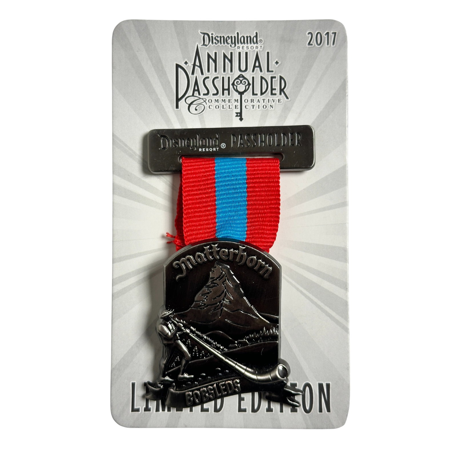 Disney DLR Matterhorn Bobsleds Ribbon Annual Passholder 2017 Pin: Disney DLR Matterhorn Bobsleds Ribbon Annual Passholder 2017 Pin. This Annual Passholder pin looks like a ribbon medal or badge that hangs from a ribbon. At the top, the bar reads "Disneyland Resort P