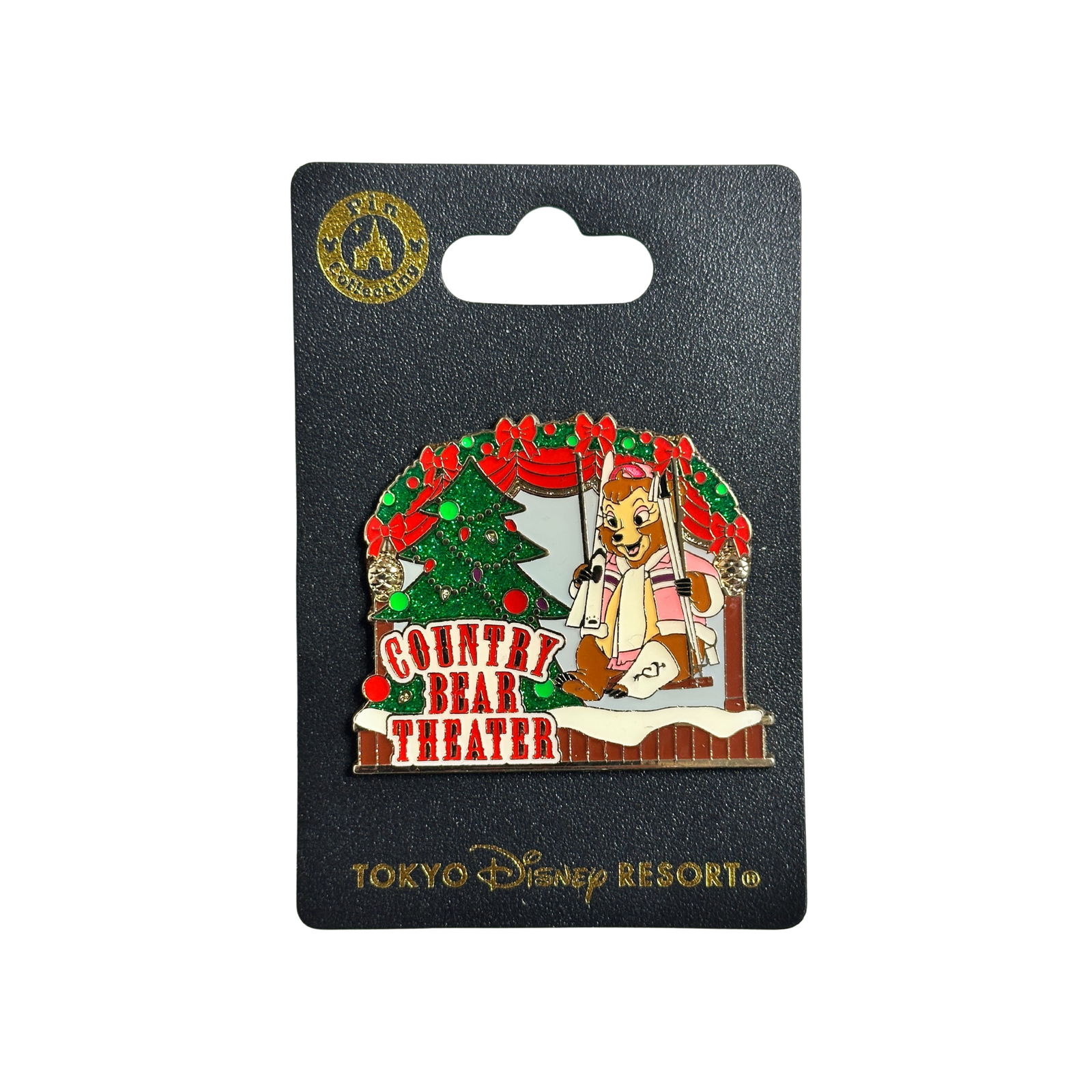 Disney TDL Country Bear Theatre Trixie Holiday Tree Pin: Disney TDL Country Bear Theatre Trixie Holiday Tree Pin. This attraction ride shows a brown bear wearing a pink winter coat with a white scarf and accents swinging on a wooden stage. There is snow ben