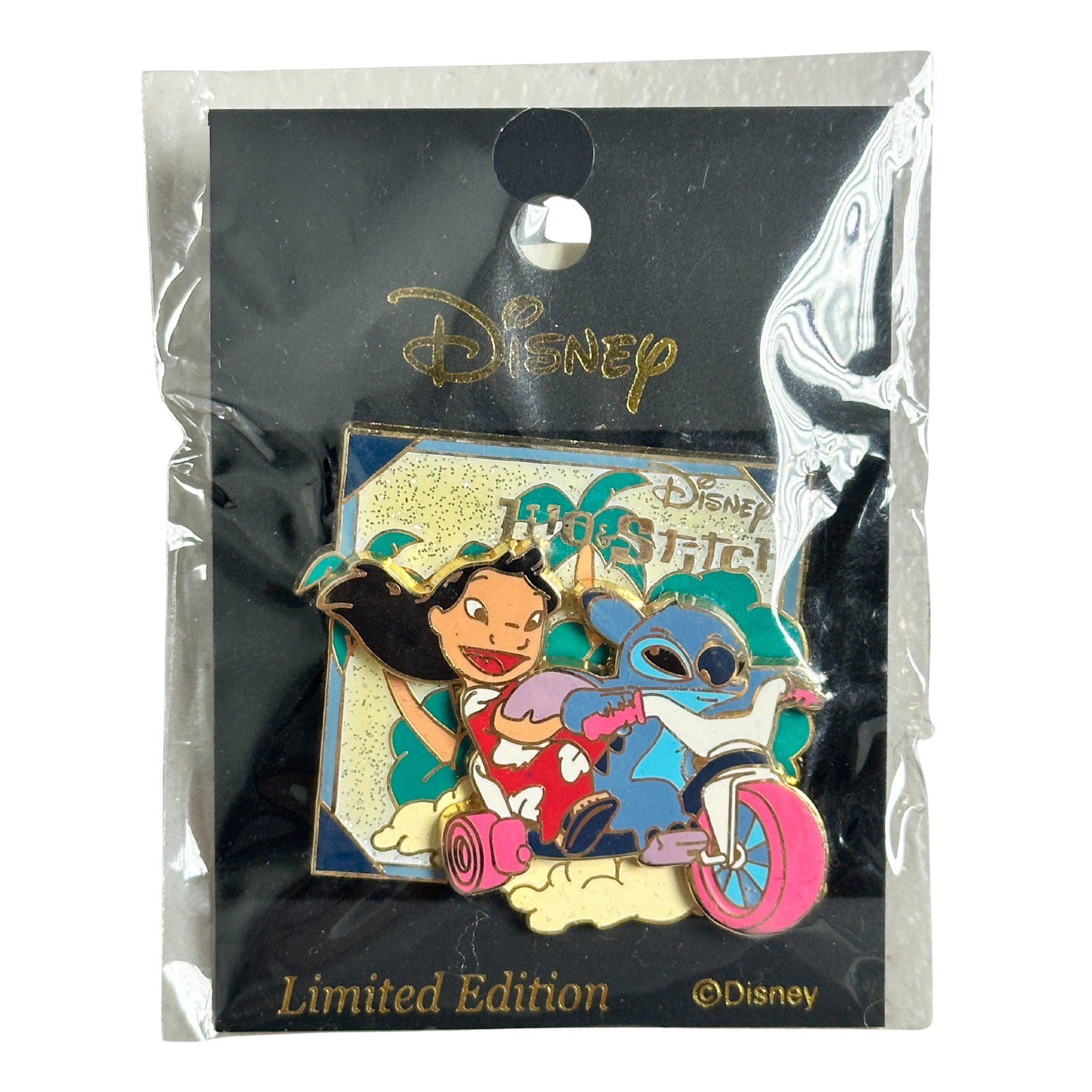 Disney TDR Lilo & Stitch Big Wheel Pin: Disney TDR Lilo & Stitch Big Wheel Pin. This 3D pin features the Lilo and Stitch. Stitch and Lilo are riding on a big wheel. Stitch is driving and Lilo is the passenger. Lilo is wearing her traditiona