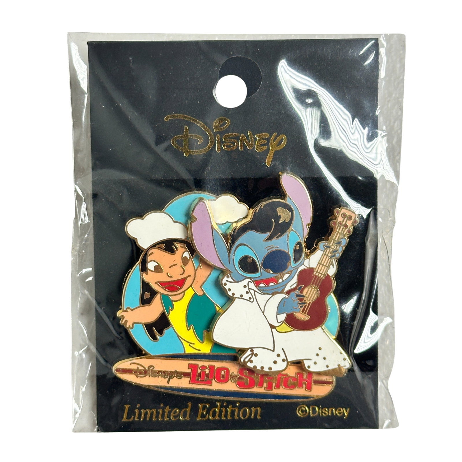 Disney TDR Lilo & Stitch Elvis Beach Pin: Disney TDR Lilo & Stitch Elvis Beach Pin. This 3D pin features Lilo and Stitch. Stitch and Lilo are on the beach in the famous beach scene where Stitch is playing Elvis. Stitch is wearing a white sequ