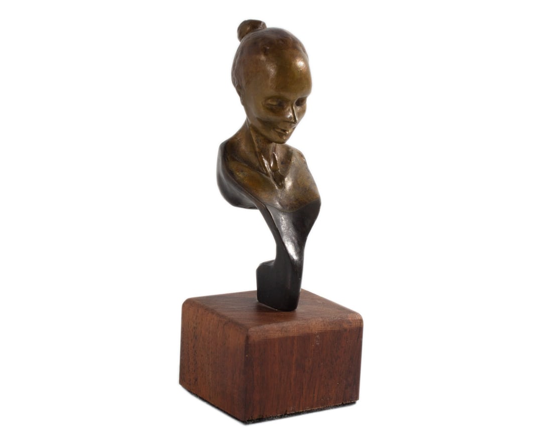 Andrew DeVries Bronze Bust of a Woman: Bronze sculpture of a female bust by Andrew Devries (American; born 1957). Initialed "ADV" to back. Measurements: 2” W x 5.5” H x 1.5” D. In house shipping
