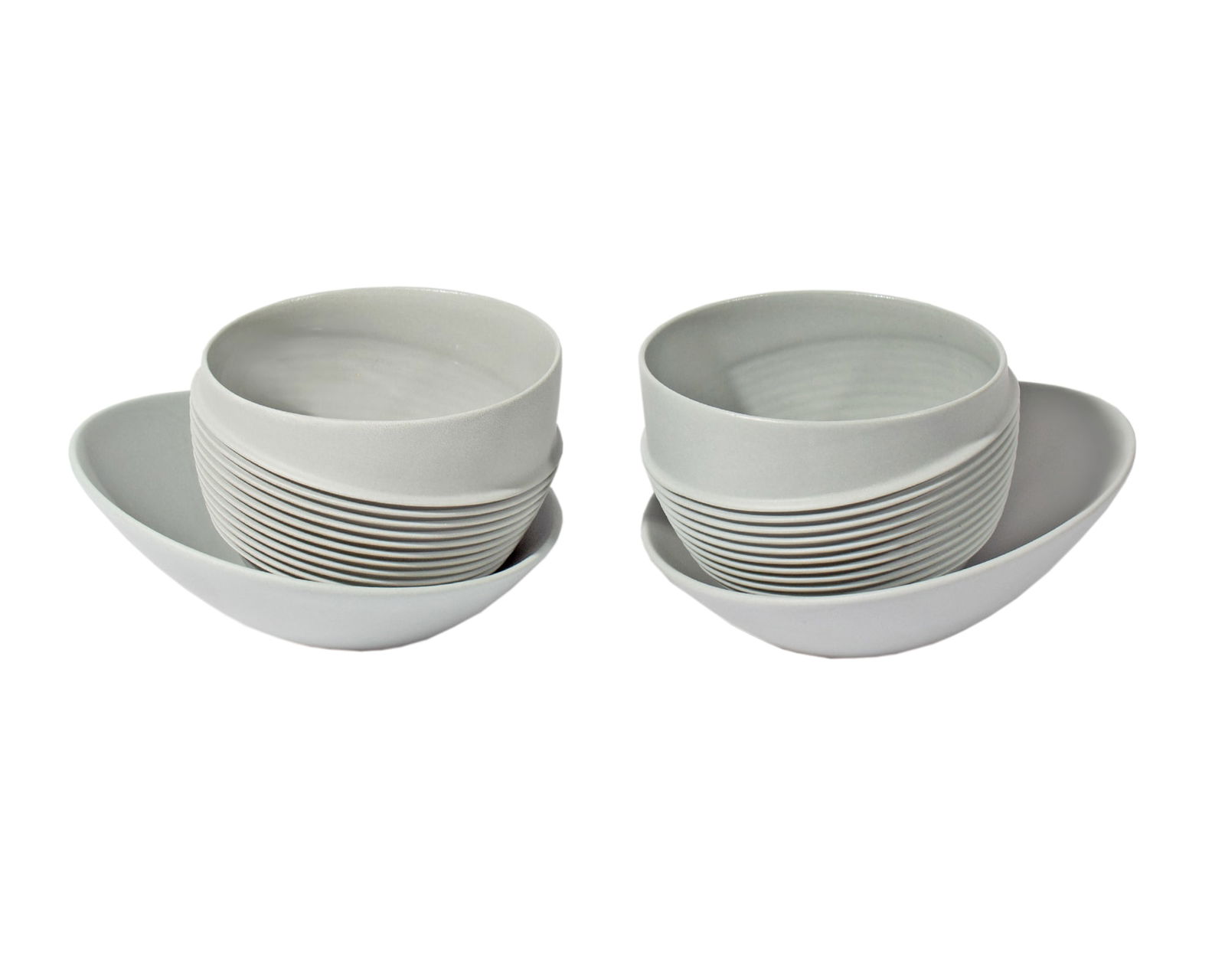 Crucial Detail Chicago "Gravity Free" Cups and Saucers: Pair of "Gravity Free" ceramic cups and saucers produced by Chicago award-winning design company Crucial Detail. Cups marked "Crucial Detail Chicago" to underside. Mea