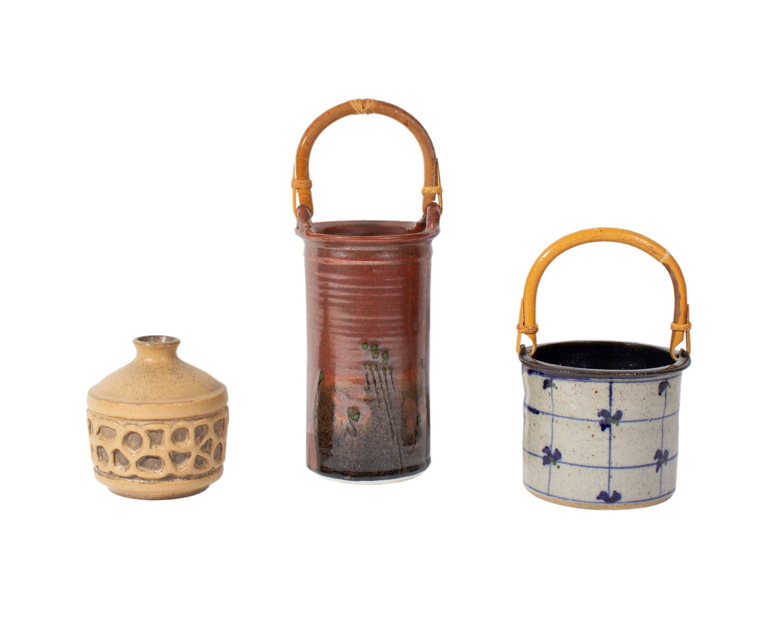 Studio Pottery Collection: Group of three studio pottery pieces. Included is a tall red basket with bamboo handle signed "Cash," a shorter basket with bamboo handle and blue design marked with a "JP" chopmar