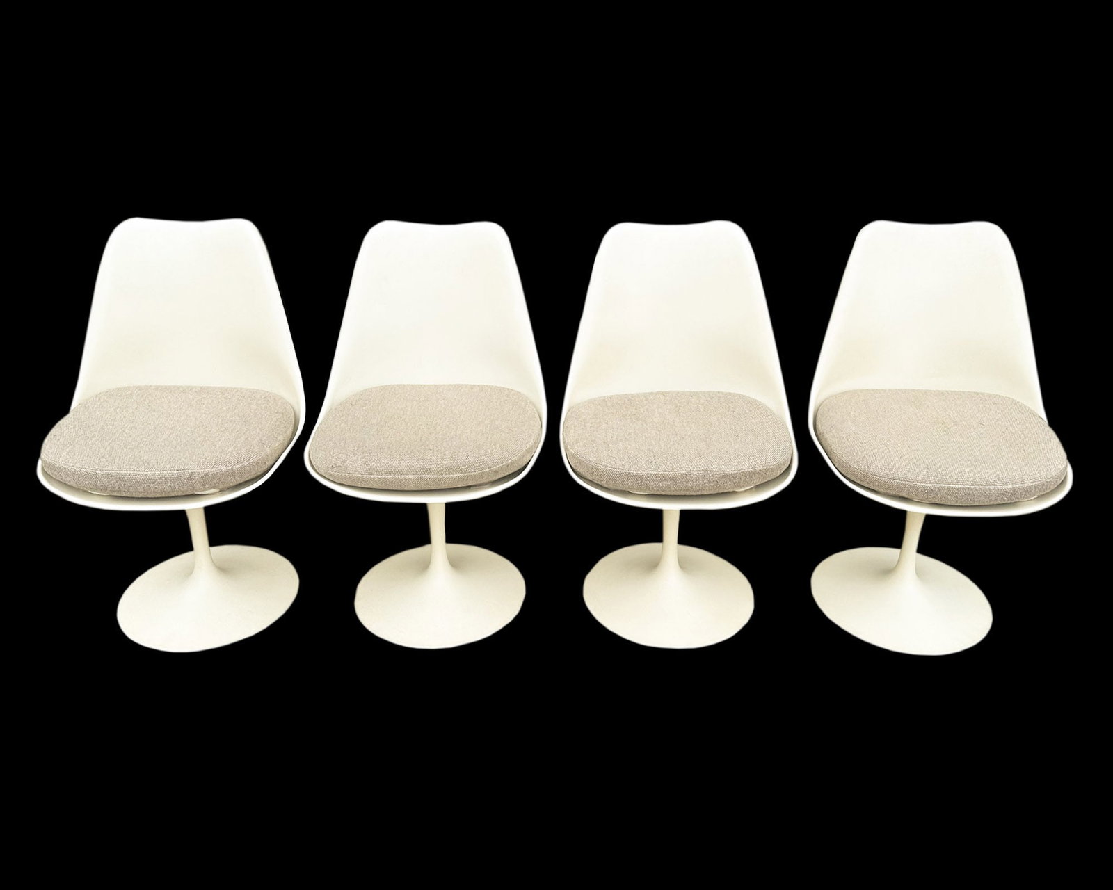 Eero Saarinen Knoll Tulip Dining Chairs, Set of Four: Set of four Tulip dining chairs designed by Eero Saarinen for Knoll. One chair marked under cushion. Metal bases, fiberglass shells. Comes with original yellow seat covers. Measurements: 1