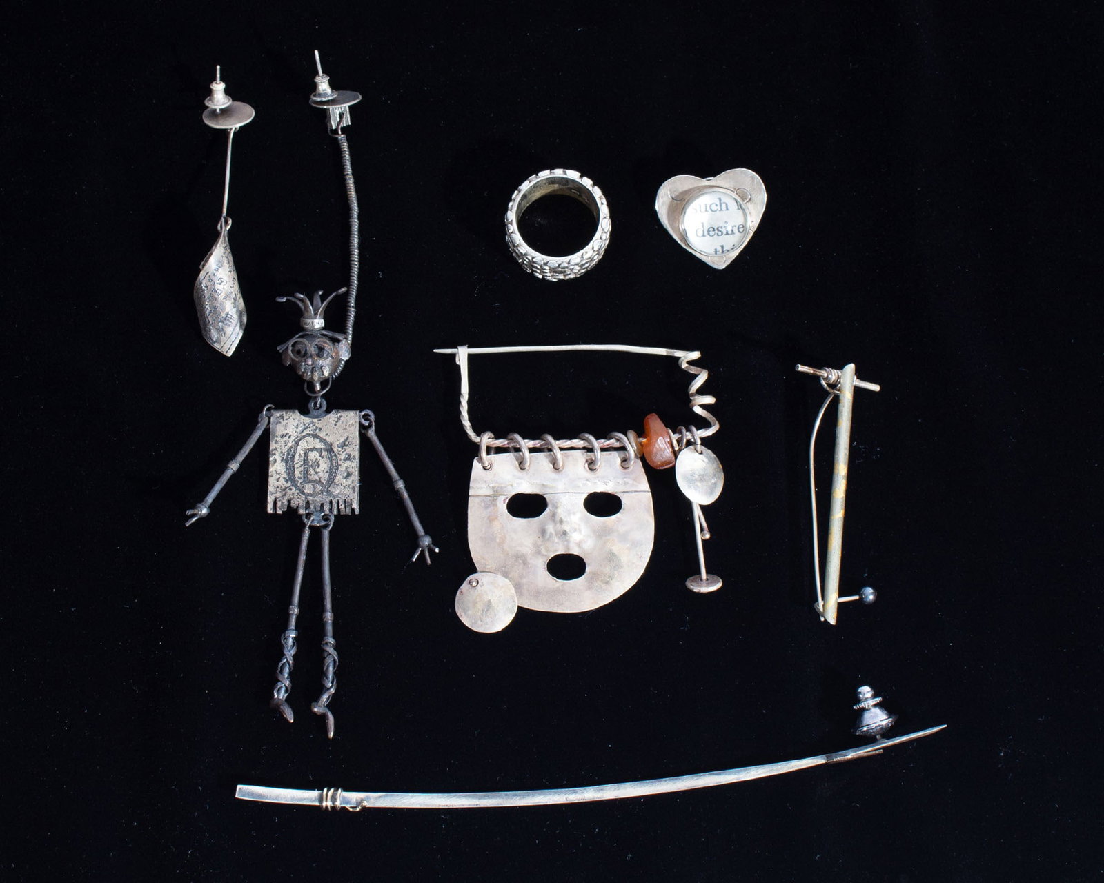 Sterling, Silver Artisan Made Jewelry: Group of silver and sterling artisan made jewelry. Ring marked "925." Heart-shaped pin signed to back. All unmarked jewelry tested as silver. Measurements: 6" (longest pin); 1.87