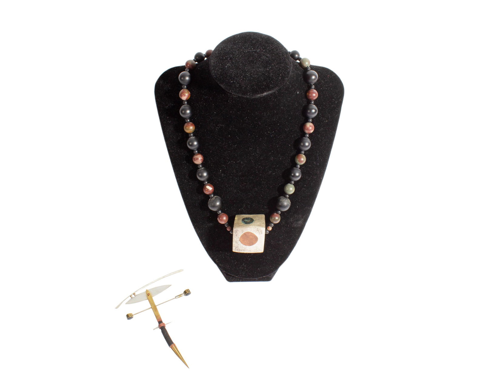 Modernist Jewelry: Two pieces of modernist jewelry. Included is a beaded necklace with stone beads and a single cube-shaped metal bead and a mixed metal brooch/pin. Both pieces unmarked. Measurements: 25.5"