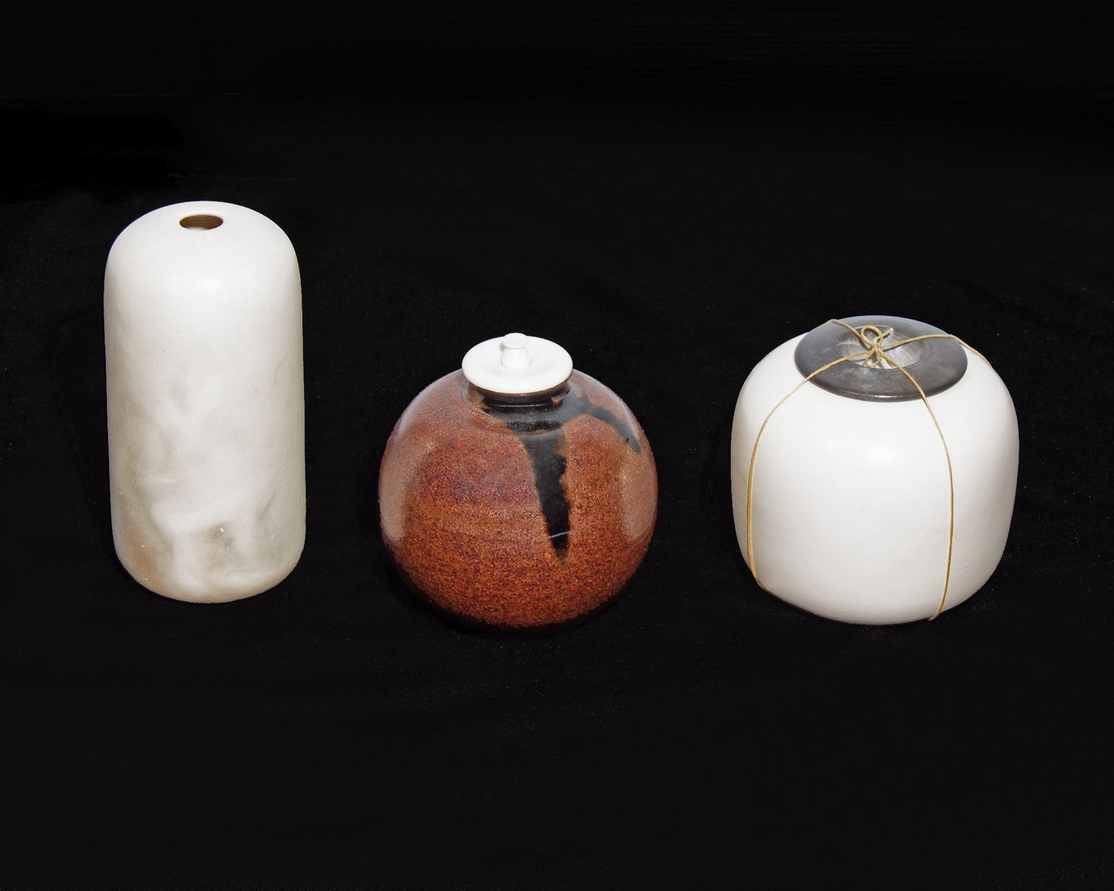 Sylvia Bower 1980s "Painting with Fire" Vessels: 1980s group of three porcelain and stoneware studio pottery vessels by ceramic artist Sylvia Bower (American; 20th century). Each vessel marked with Bower's chopmark. One vessel wrapped with twine