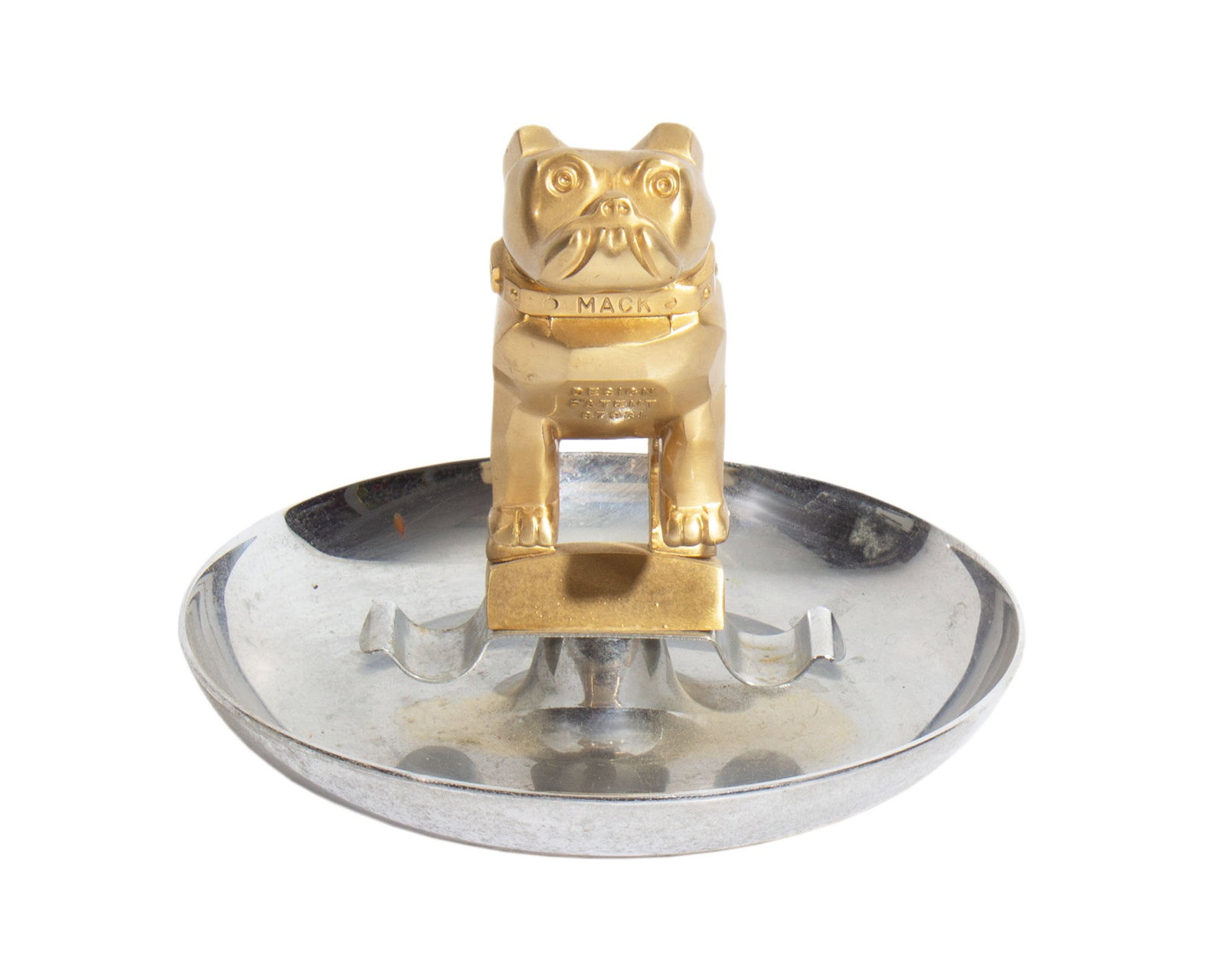 Mack Truck Bulldog Cigar Ashtray: Chrome cigar ashtray topped with a Mack Truck bulldog hood ornament. Marked "Mack Design Patent 87931" to front of dog, marked "Central Die Casting & Mfg. Co. Chicago USA" to