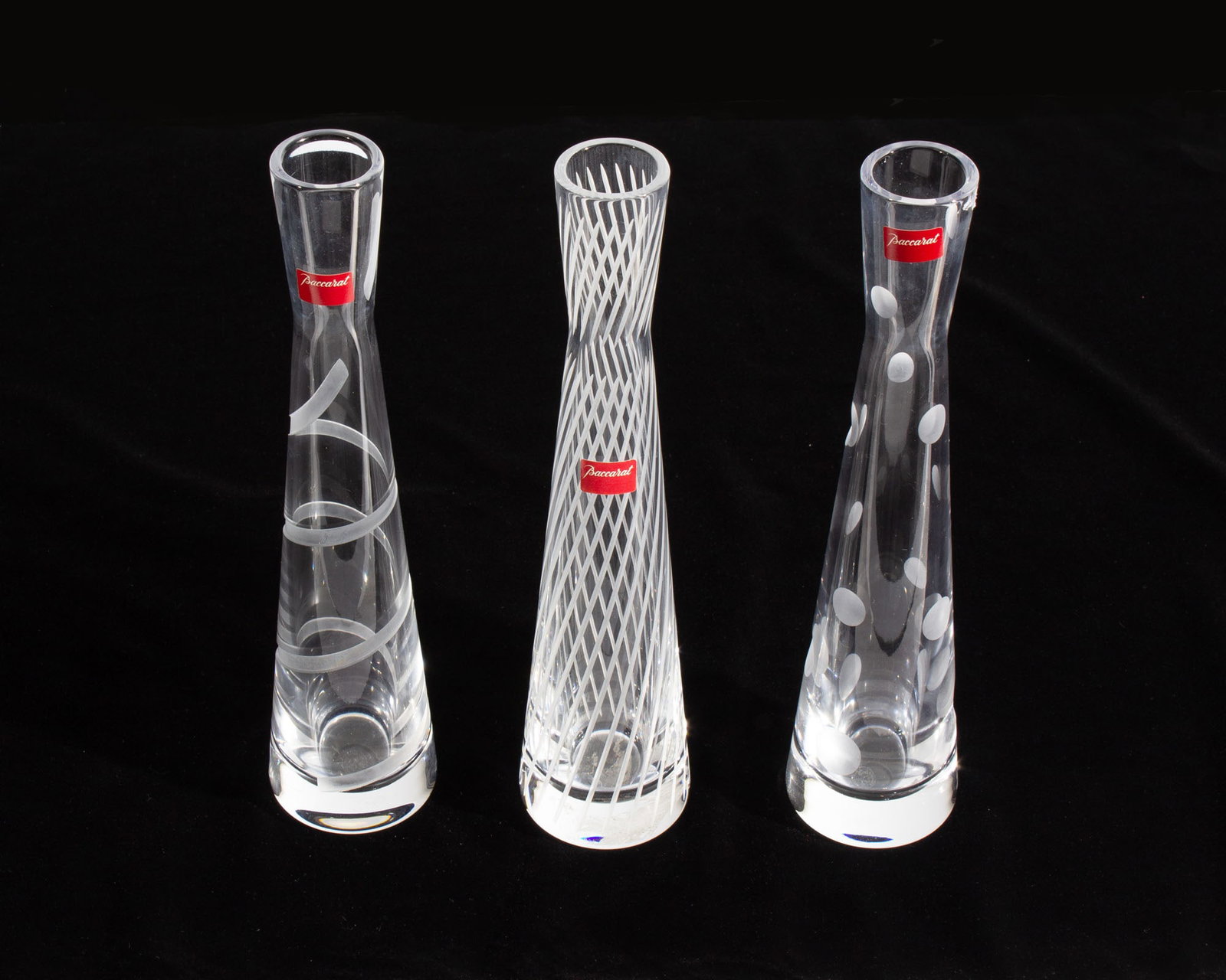 Baccarat Crystal Passion Collection Bud Vases: Group of three crystal bud vases from the Passion Collection produced by Baccarat. Included are the vases with the "Mikado Passion," the "Passion Voltige," and the "Crown