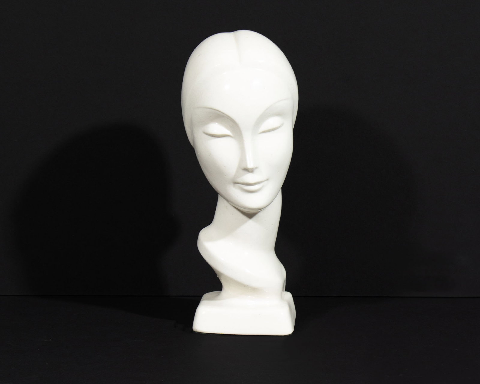 AMACO American Art Clay Company Art Deco Bust: Art Deco ceramic bust produced by AMACO (American Art Clay Company) of Indianapolis. Marked to underside. Measurements: 2.75” W x 6.75” H x 3” D. In house