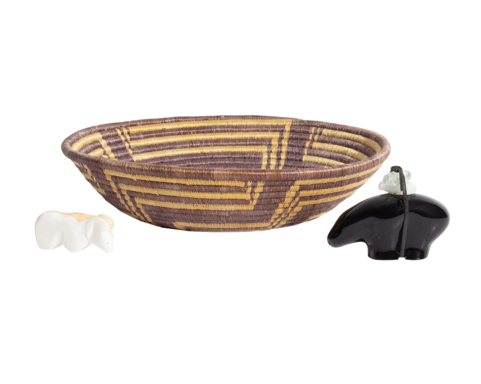 Zuni Fetish and Southwestern Style Decor: Carved stone Zuni fetish, a Southwestern style woven basket, and a 1988 Oneida "Mystic Animal" bear. Measurements: 11.5" W x 2.5" H x 11.5" D (basket). In