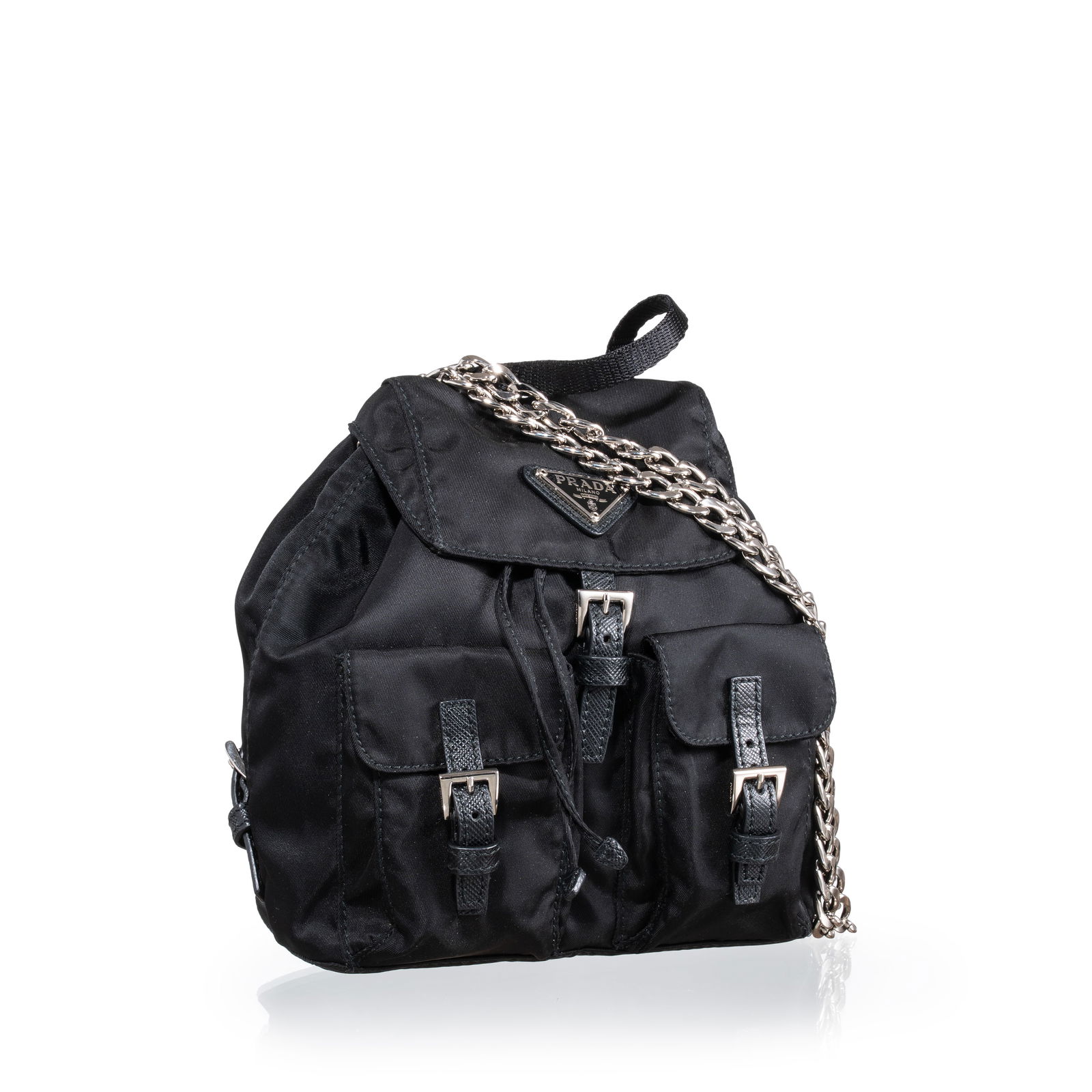 PRADA MINI BACKPACK RE-EDITION IN BLACK SAIL CLOTH: Brand: Prada Model: Re-Edition mini rucksack Material: Vela canvas and Saffiano details Colour: Black and palladium hardware Dimensions: 18 x 18 x 8 cm (W x H x D) Notes: Chain shoulder strap that can