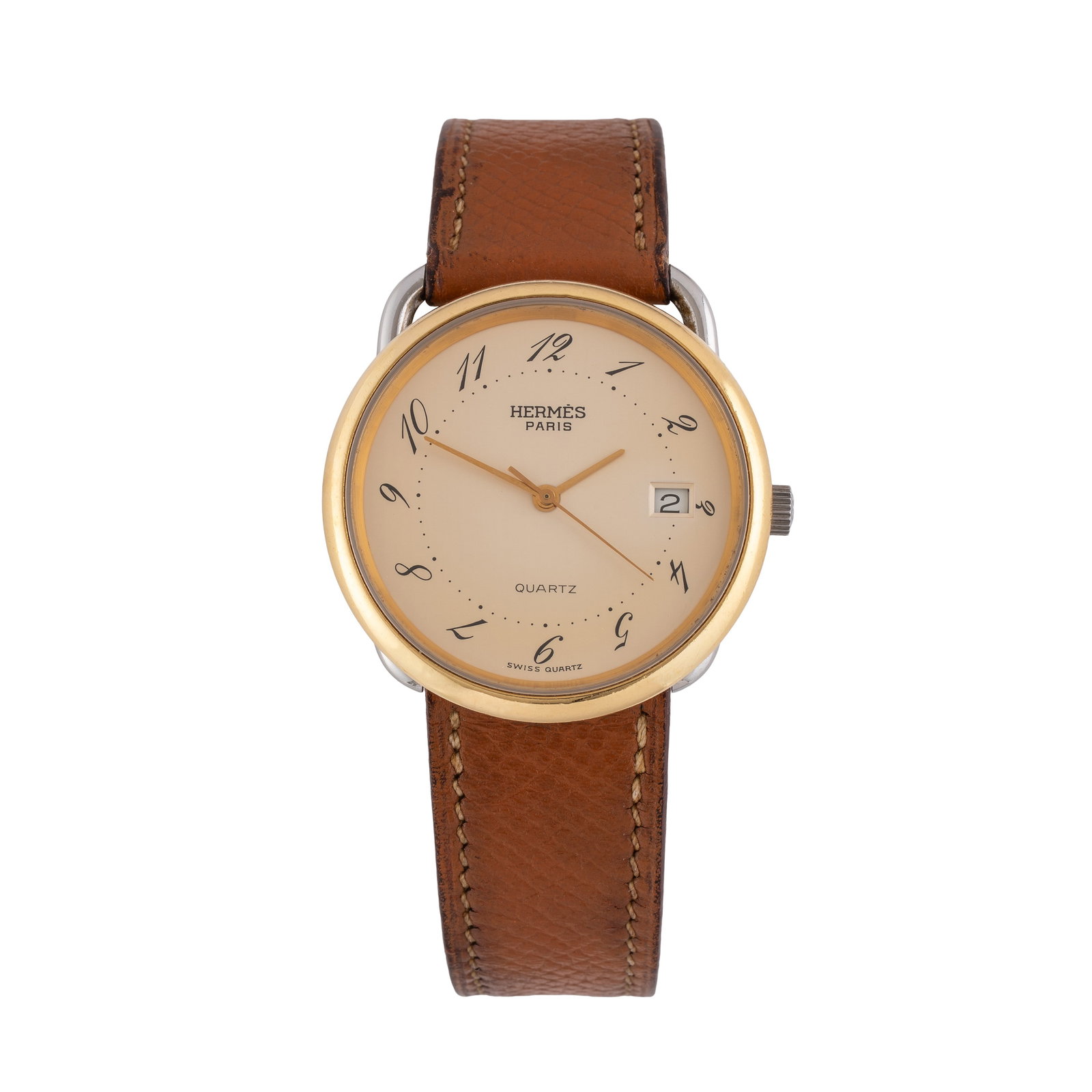 HERMÈS QUARTZ TIME-ONLY WATCH IN STEEL WITH CHAMPAGNE DIAL GOLD-TONED BEZEL AND DATE AT 3: Brand: Hermès Model: Quarz Year: 1990s Dial: Champagne Case no.: 10XXX Movement: Quartz Case material: Steel Bracelet/strap: Leather Case size: 33 mm Notes: Quartz time-only watch in steel with gold-