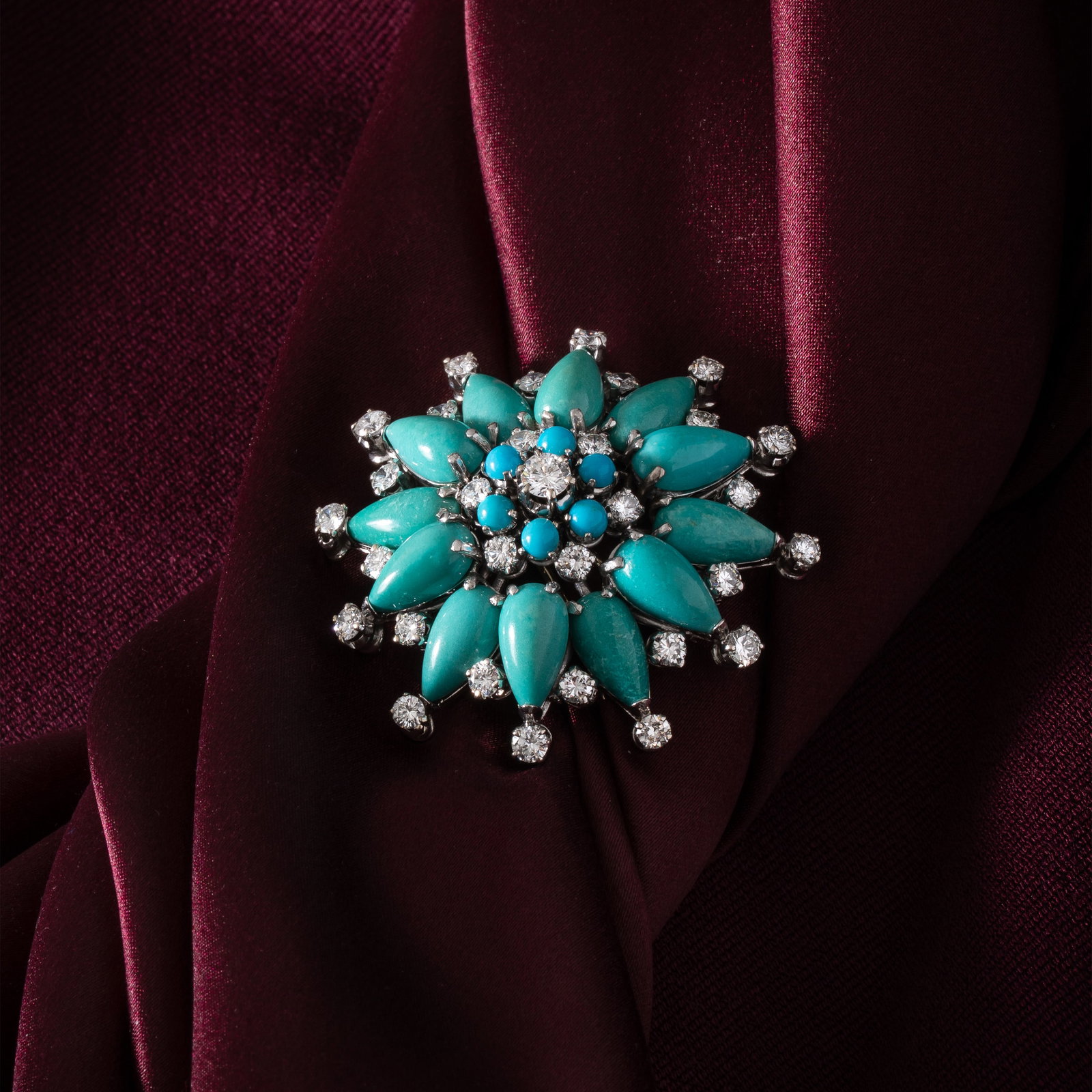 MISSIAGLIA - BROOCH WITH TURQUOISE AND DIAMONDS: Brooch featuring eighteen turquoise stones estimated at 13 carats in strong greenish blue and light blue hues in teardrop and round shapes cabochon-cut and thirty-one diamonds including a 0.20-carat c