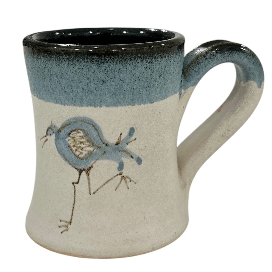 Small Wild Signed Blue and White Stoneware Mug with Roadrunner: This small, Wild signed stoneware mug is a must-have for any collector or lover of unique, handcrafted pottery. The mug features a beautiful blue and white design with a roadrunner pattern that is sur