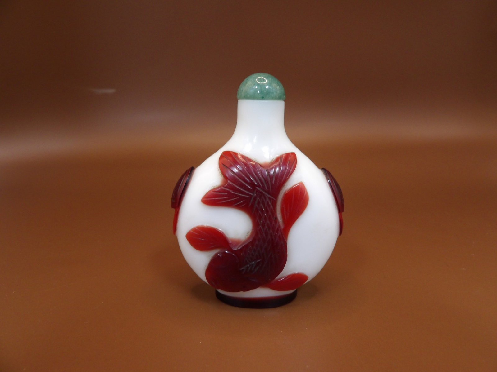 Chinese milk glass snuff bottle with red overlay fish motif: 2.5 inches height.
