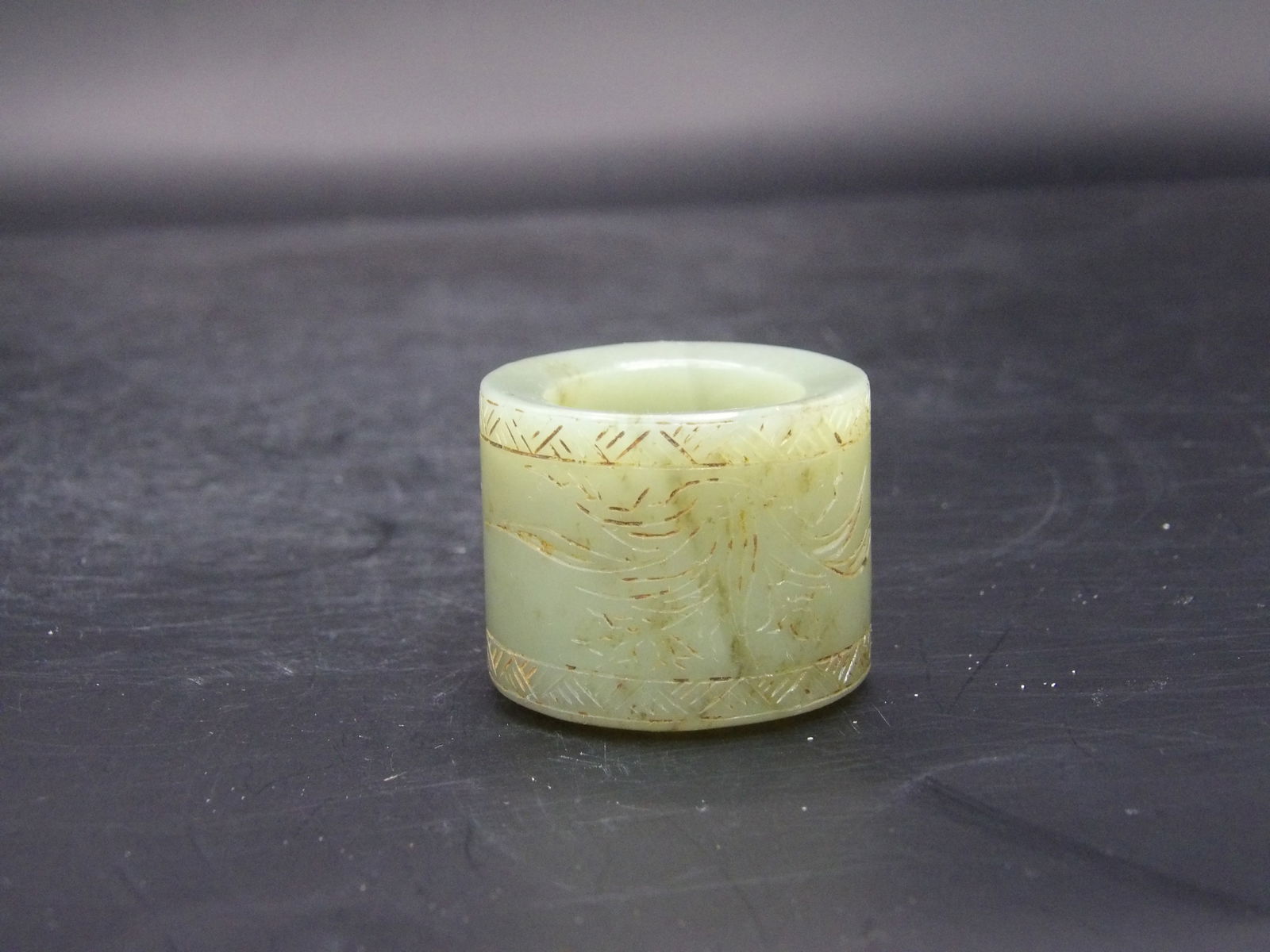 Chinese Nephrite Jade Archer Ring: 42.8 grams. 1 x 1.25 x 1.25 inches. Carved with leaves and Chinese calligraphy.