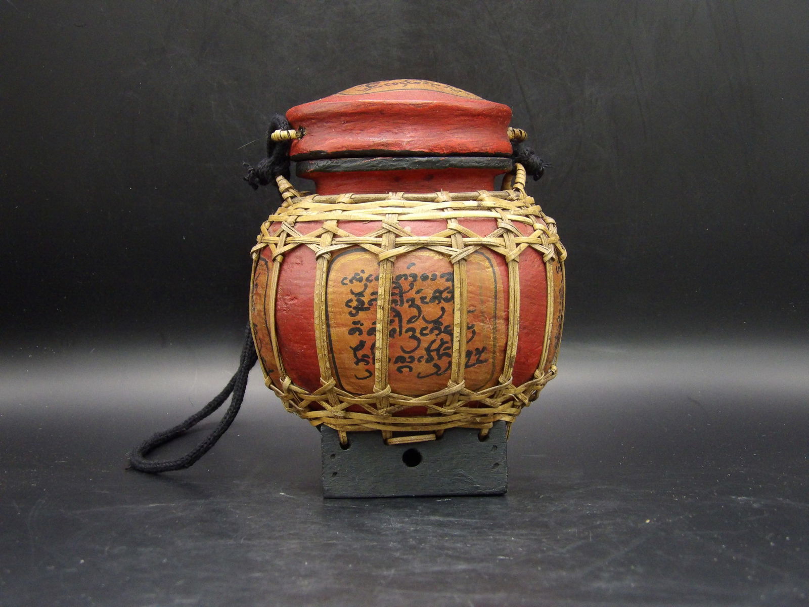 Asian Thai? Rice Basket With Lid and Rope Reddish: Reddish background color with calligraphy. 5.3 inches height.