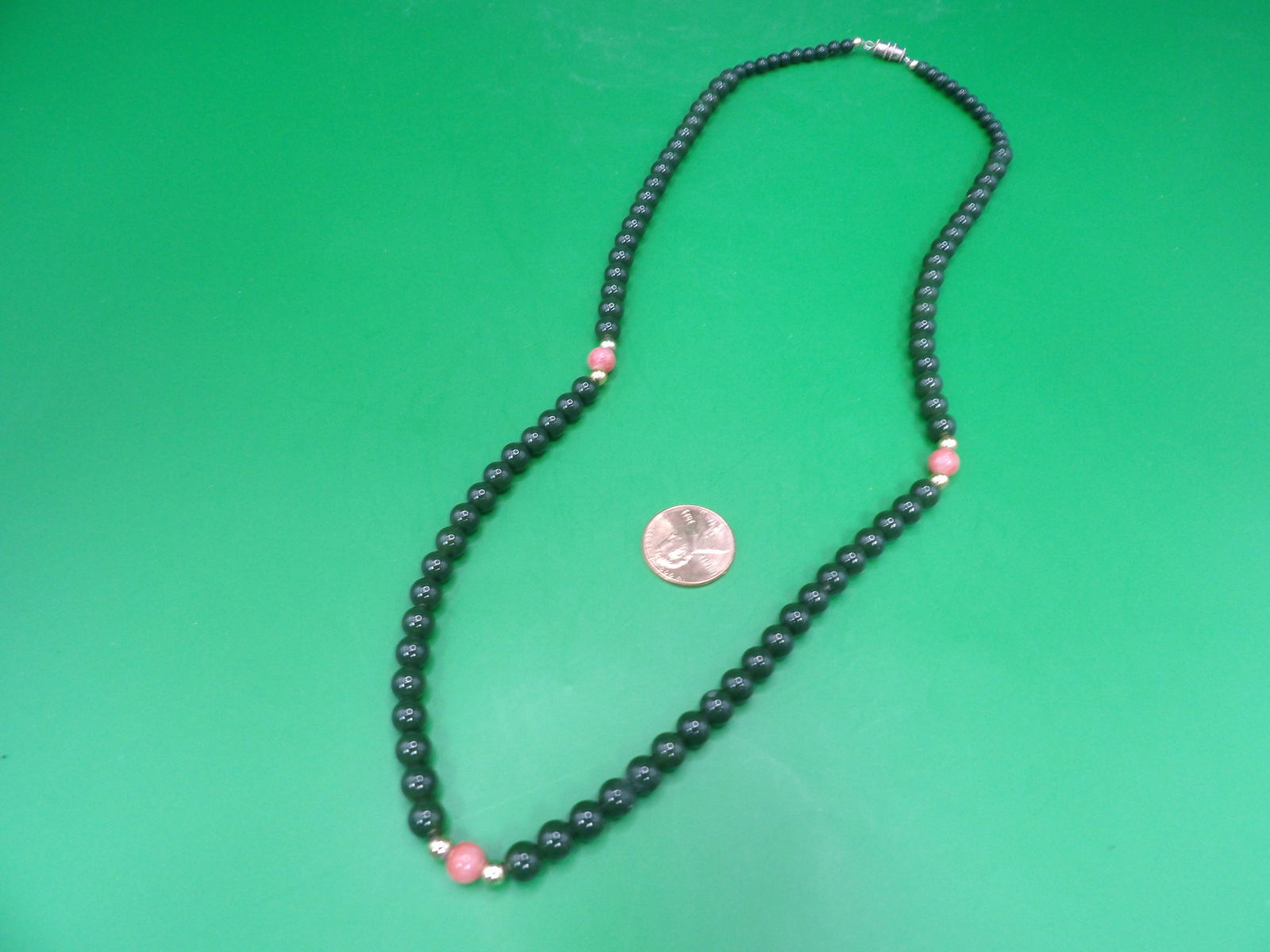 Green jade and angel skin coral beaded necklace: 22 inches length.