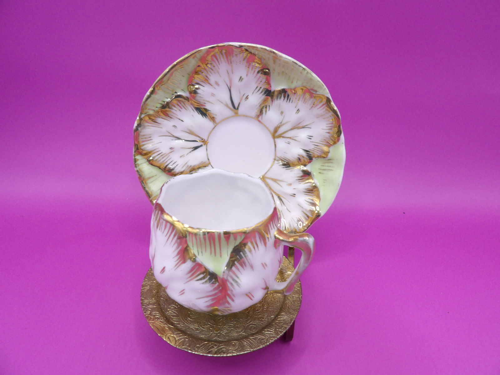 Gold gilt eggshell porcelain tea cup and saucer on brass stand: Saucer is 4 inches diameter.