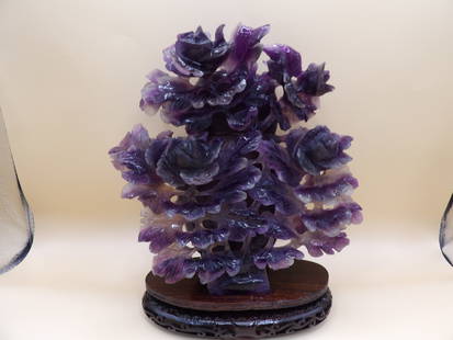 Rare Chinese amethyst carving of a vase covered with flowers on custom wood stand: 2598 grams gem weight. Vase is 8.4 inches height. With wooden stand total height 9.7 inches.