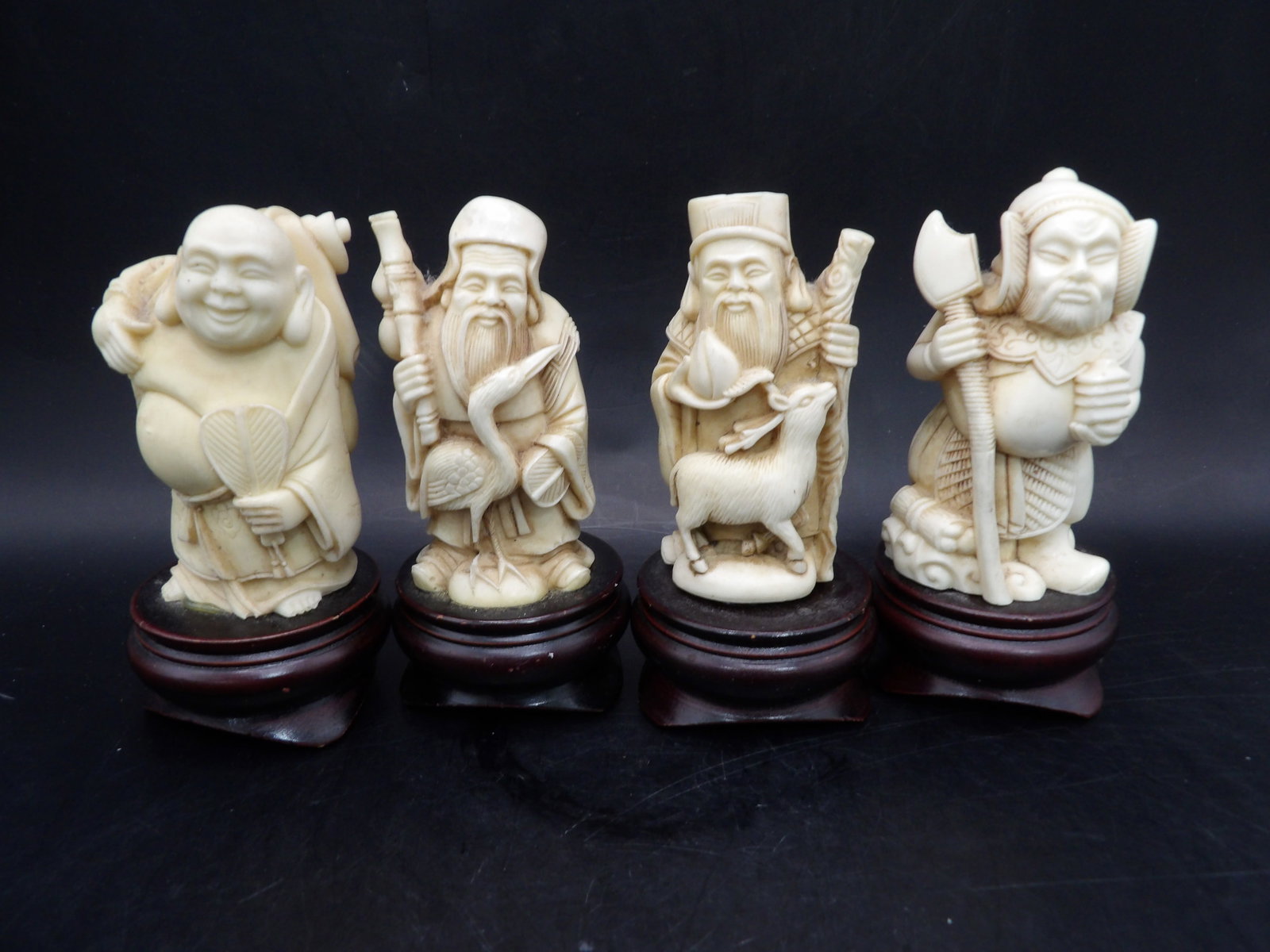 Lot of 4 Asian resin figurines with wooden base: 4 inches height including wooden base.