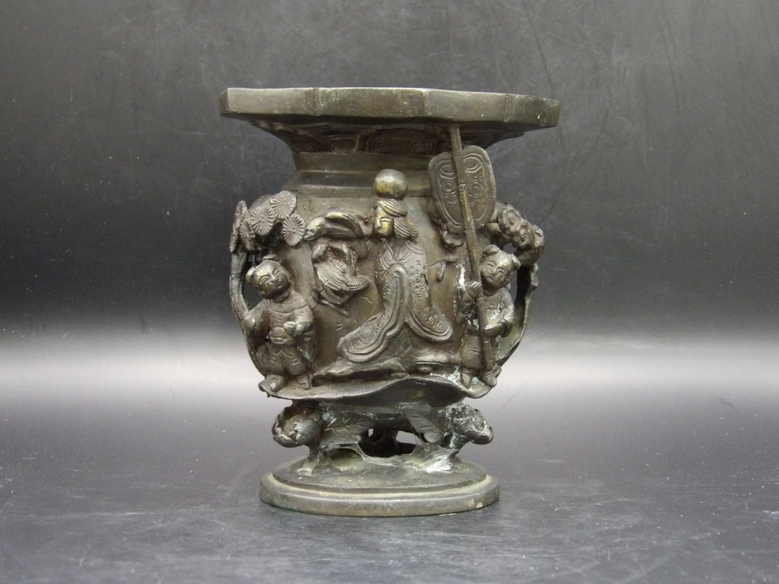 Chinese or Japanese Ornate Bronze Vase Raised Relief Signed fine details: Decorated with court lady, boy, girl and scenery. 5.5 inches height. Signed on the bottom.