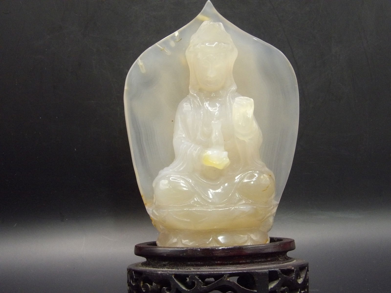 Chinese Antique chalcedony Kwan Yin Statue 5.3 inches height: Finely carved antique Chinese Kwan Yin statue. 5.3 x 3 x 1.3 inches. 540 grams. Wooden stand.