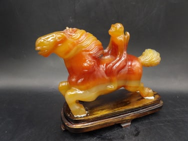 Chinese fine carnelian or agate carving of monkey riding a horse on wooden stand