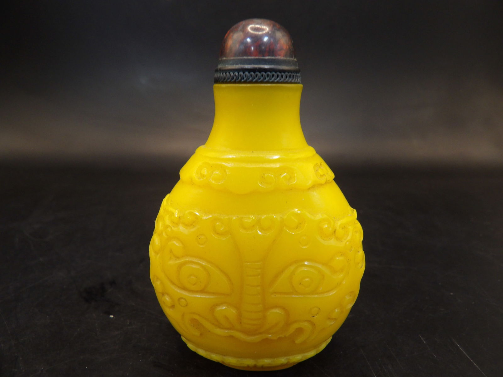 antique Chinese imperial yellow glass snuff bottle with mask face (1 of 5)