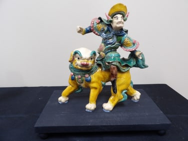 antique Chinese roof tile a warrior riding mythical creature on a base