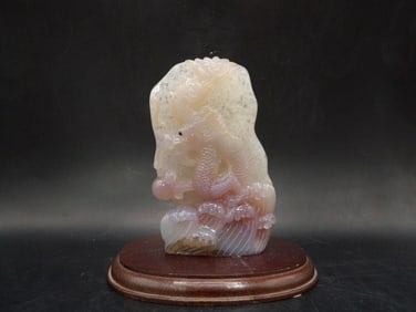 Fine Chinese carved dragon playing a pearl on wooden base probably fluorite